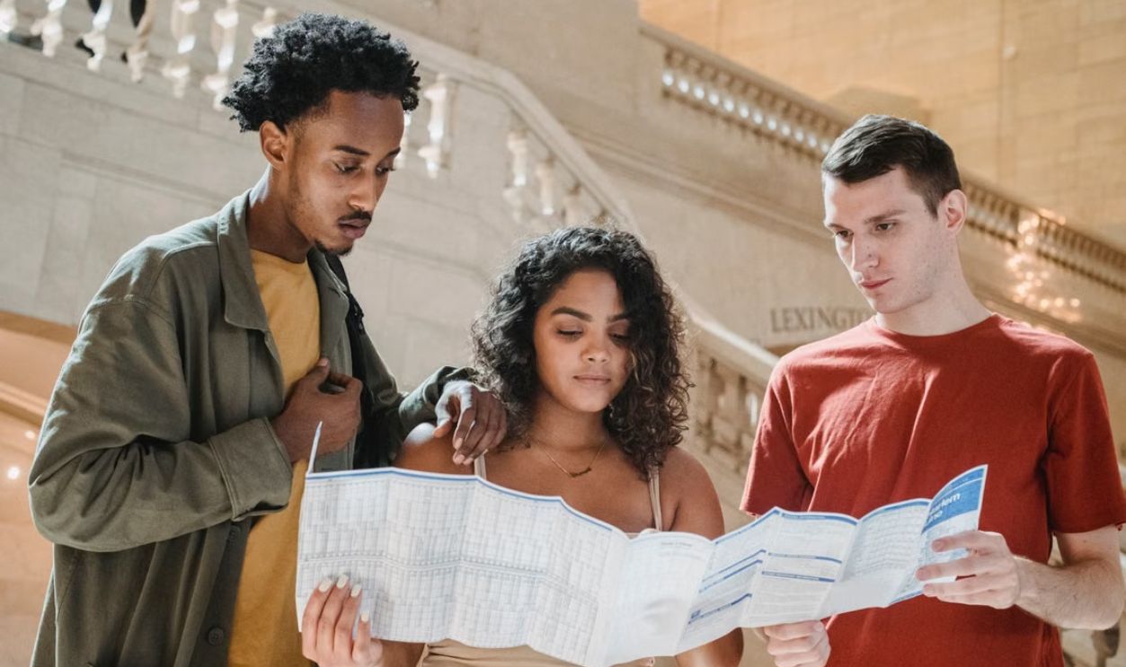 Group of travelers reading a map in Grand Central Station, New York City
