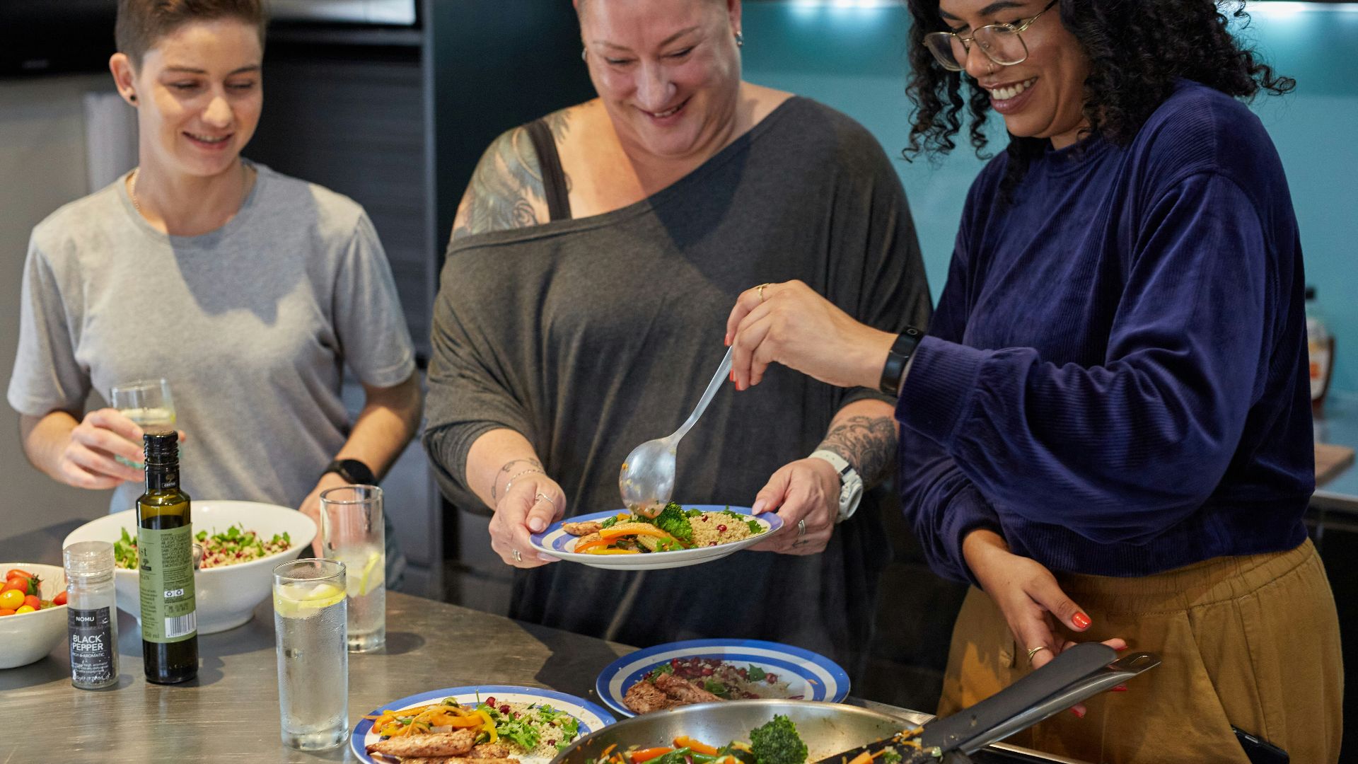 a group of people preparing food in a kitchen