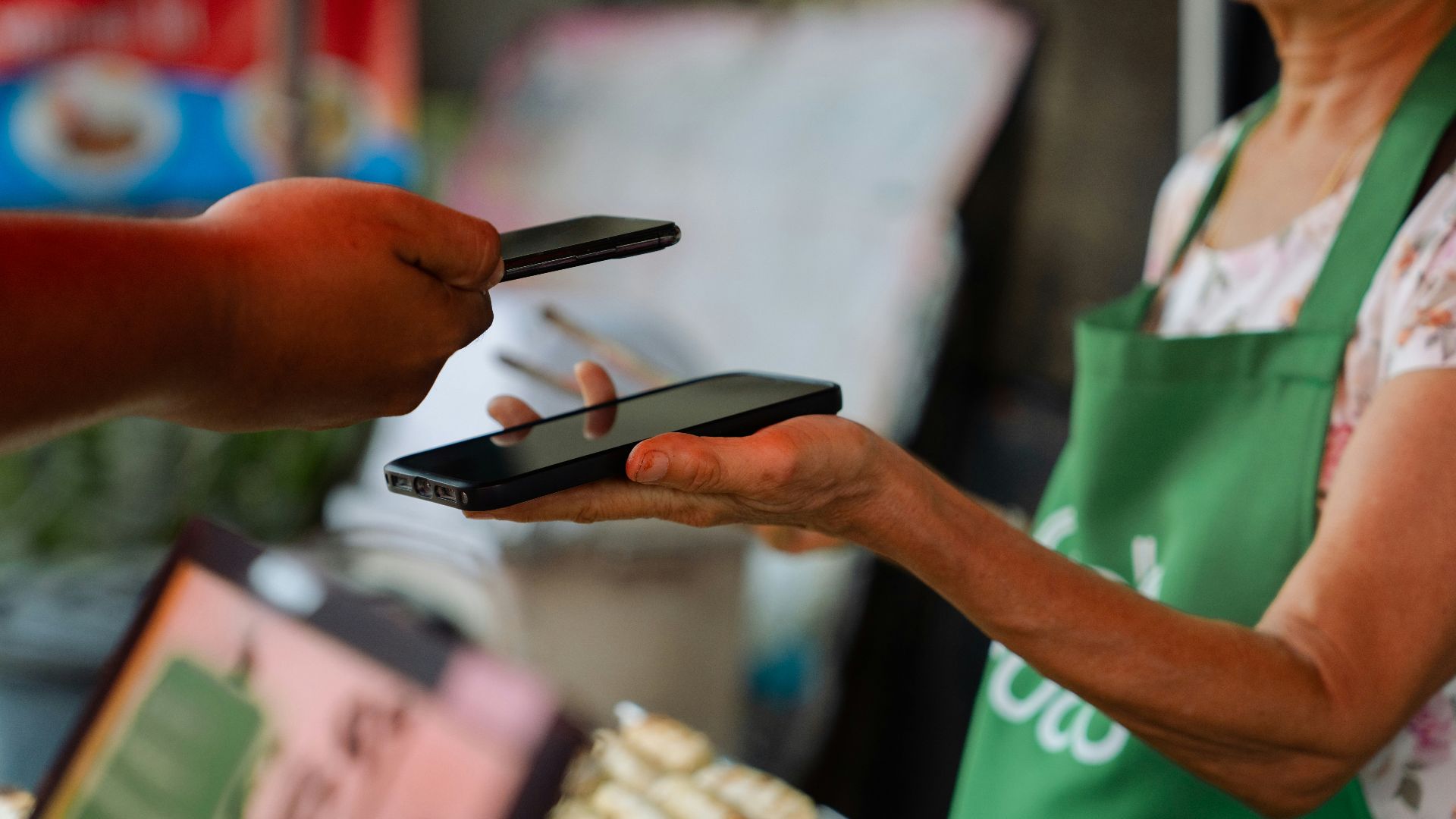 a woman holding two cell phones in her hands
