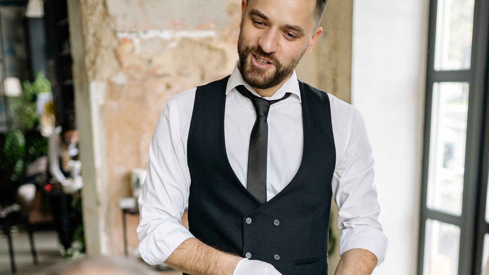 Waiter Holding a Credit Card Terminal
