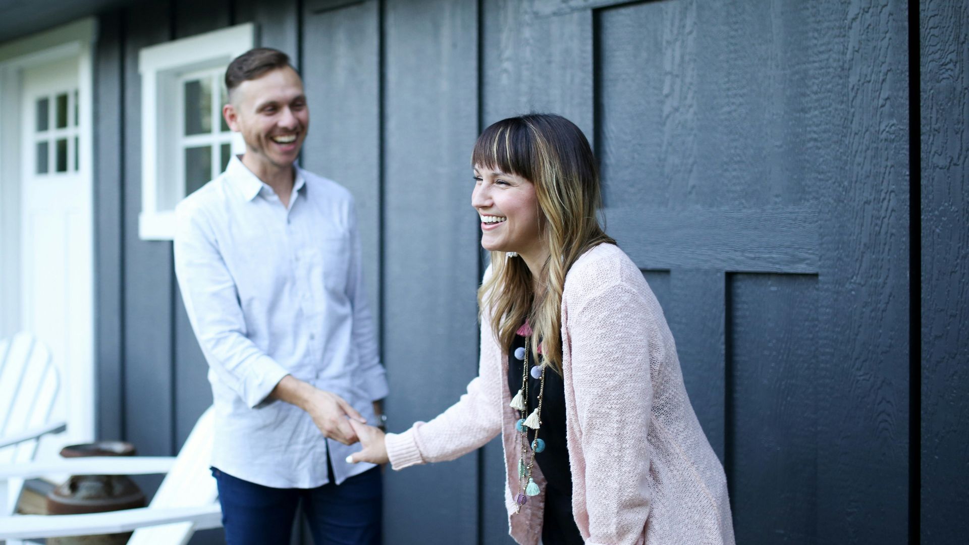 man in white dress shirt standing beside woman in gray cardigan