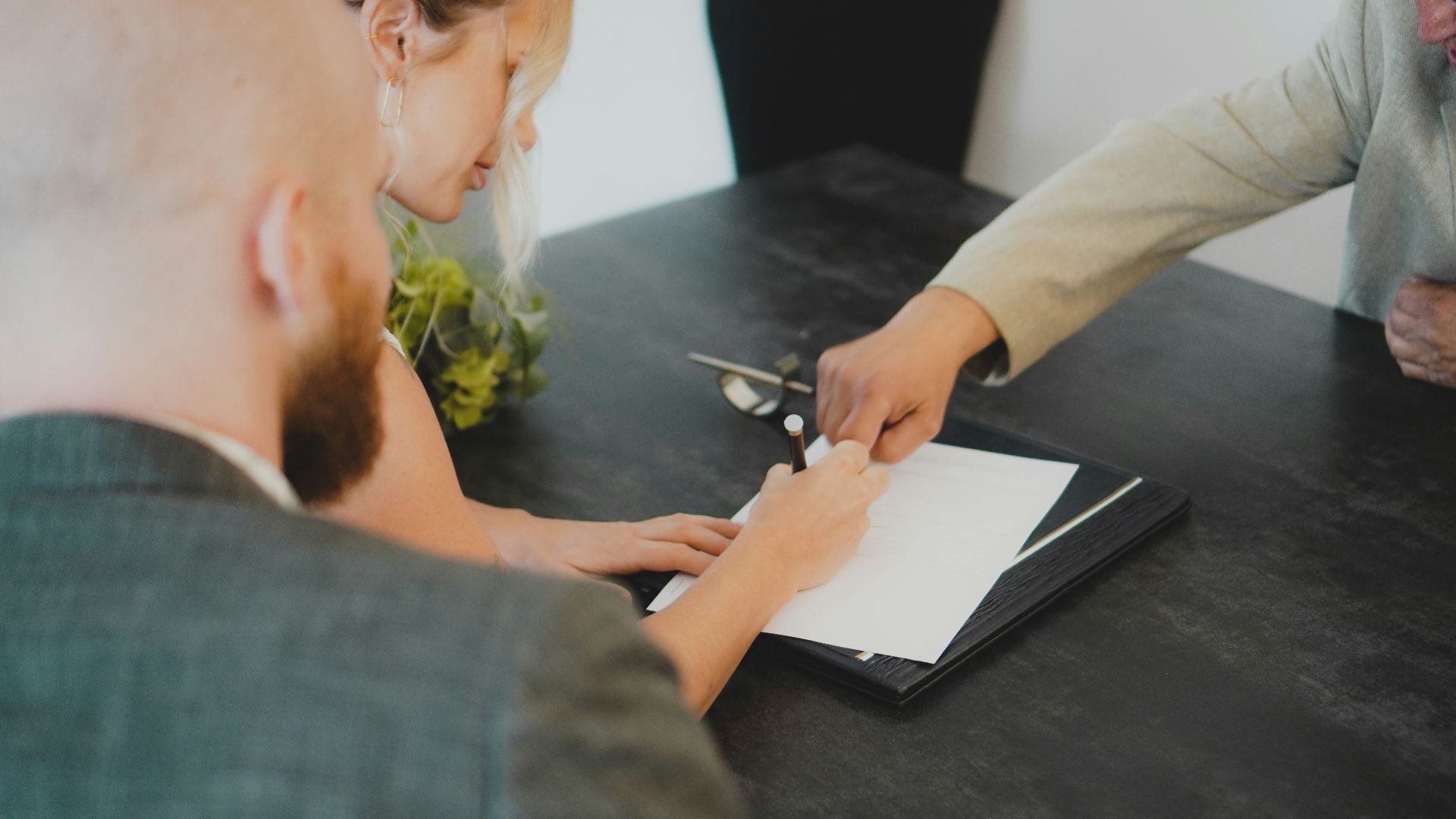 couple signing document at desk