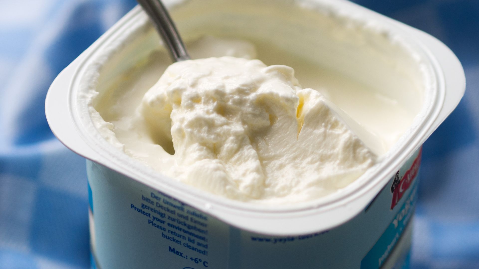 A newly opened package of Turkish Süzme Yoğurt, a strained yoghurt with a 10% fat content. Its contents have not been stirred, showing how thick the yoghurt is. The brand is Yayla, from the YAYLA-Türk company, based in Krefeld, Germany.