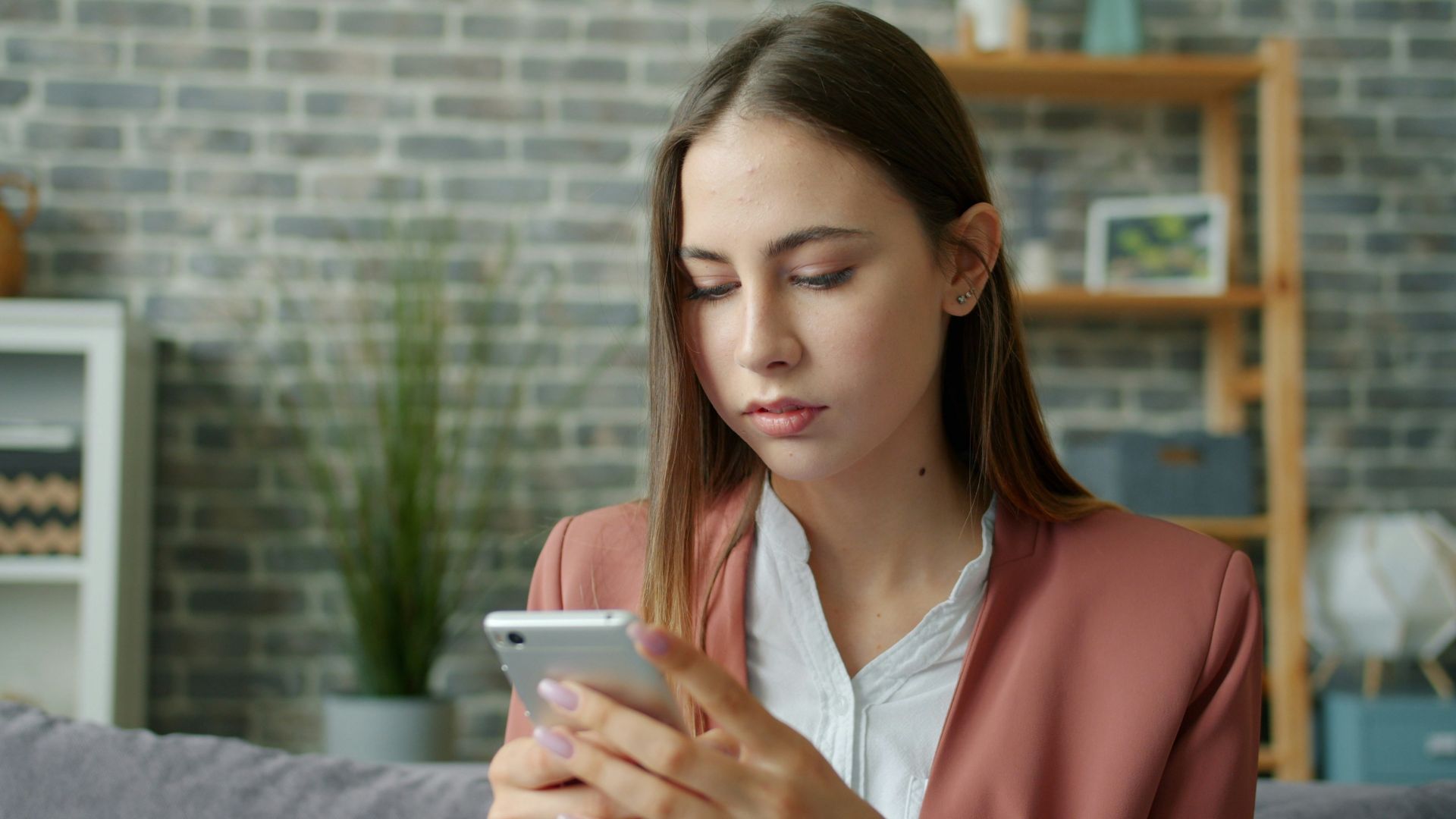 Young woman looking at her smartphone screen.