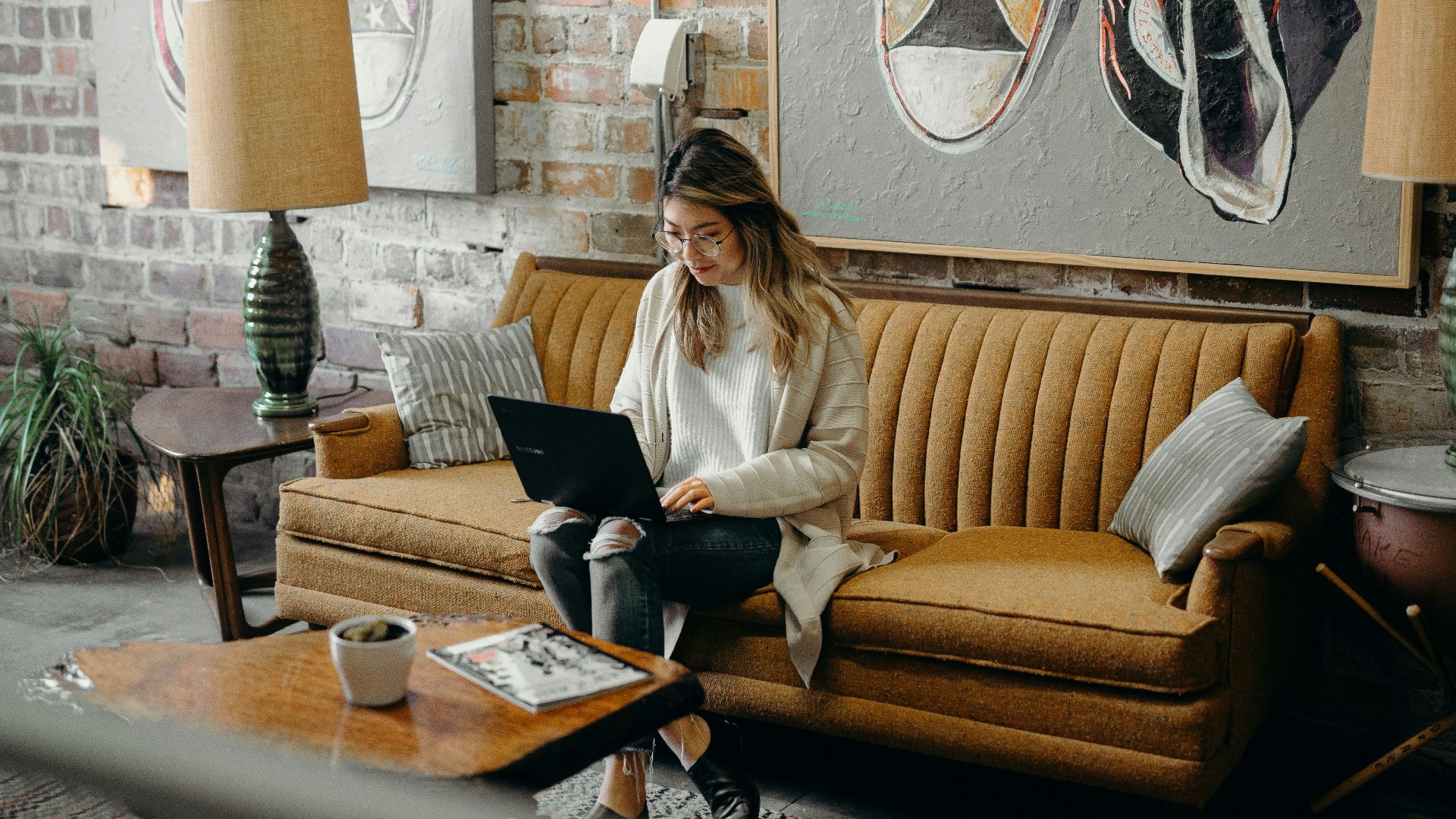woman using laptop while sitting on chair