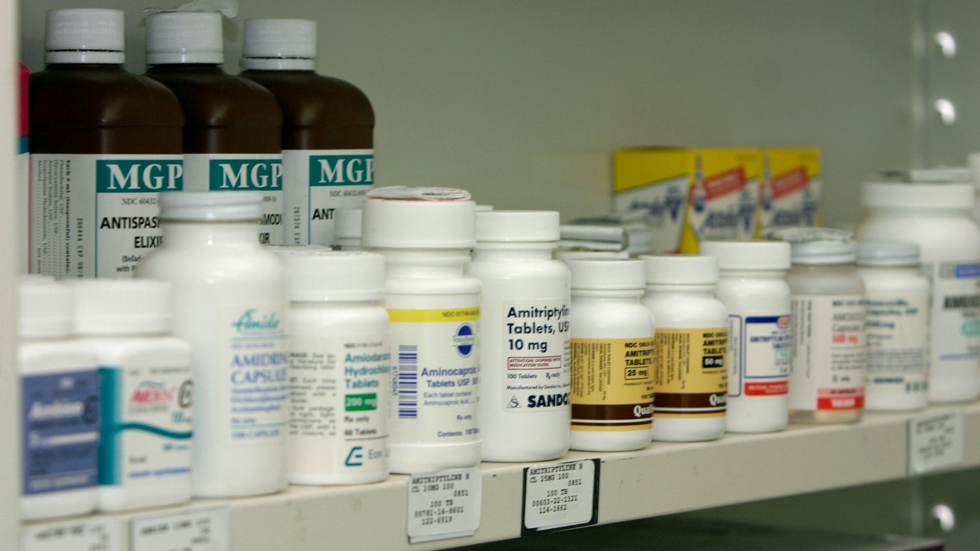 a shelf filled with lots of different types of medicine