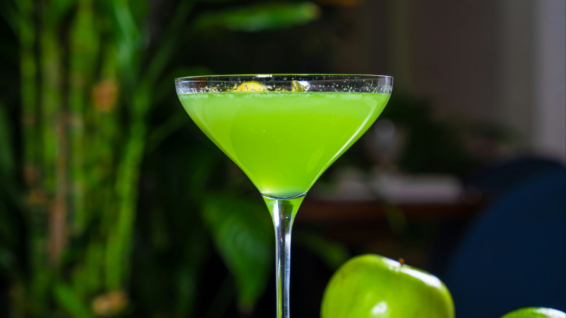 a green drink sitting on top of a table
