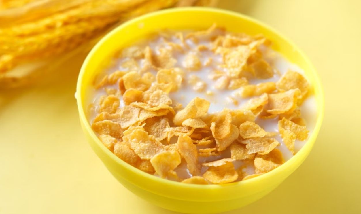 Bright cereal breakfast with milk in a yellow bowl, ideal for healthy starts.