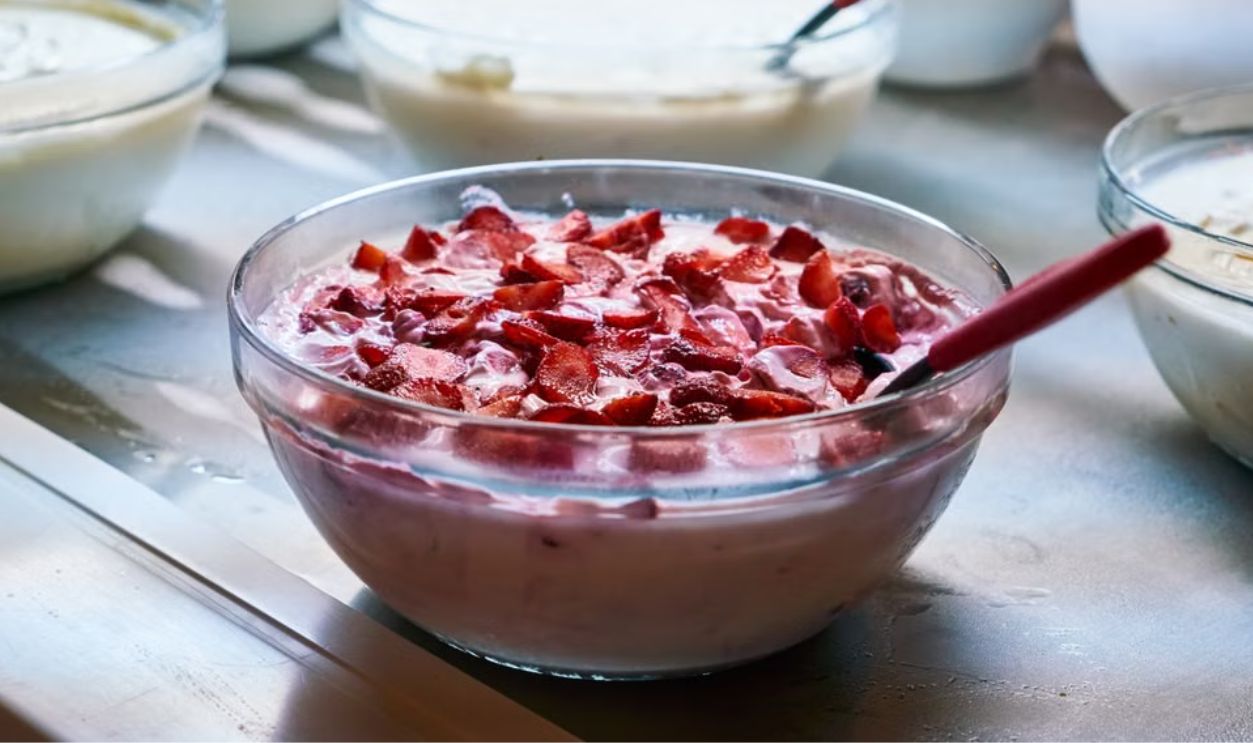 A variety of homemade yogurt dishes with fresh fruit toppings in bowls, perfect for breakfast or a healthy snack.
