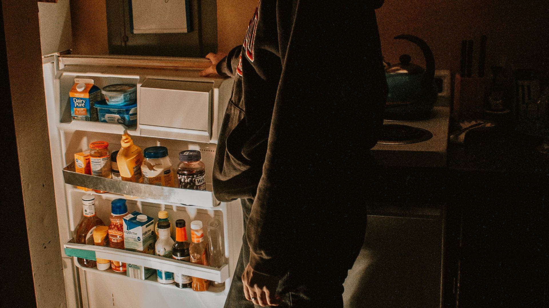 a man standing in front of a refrigerator