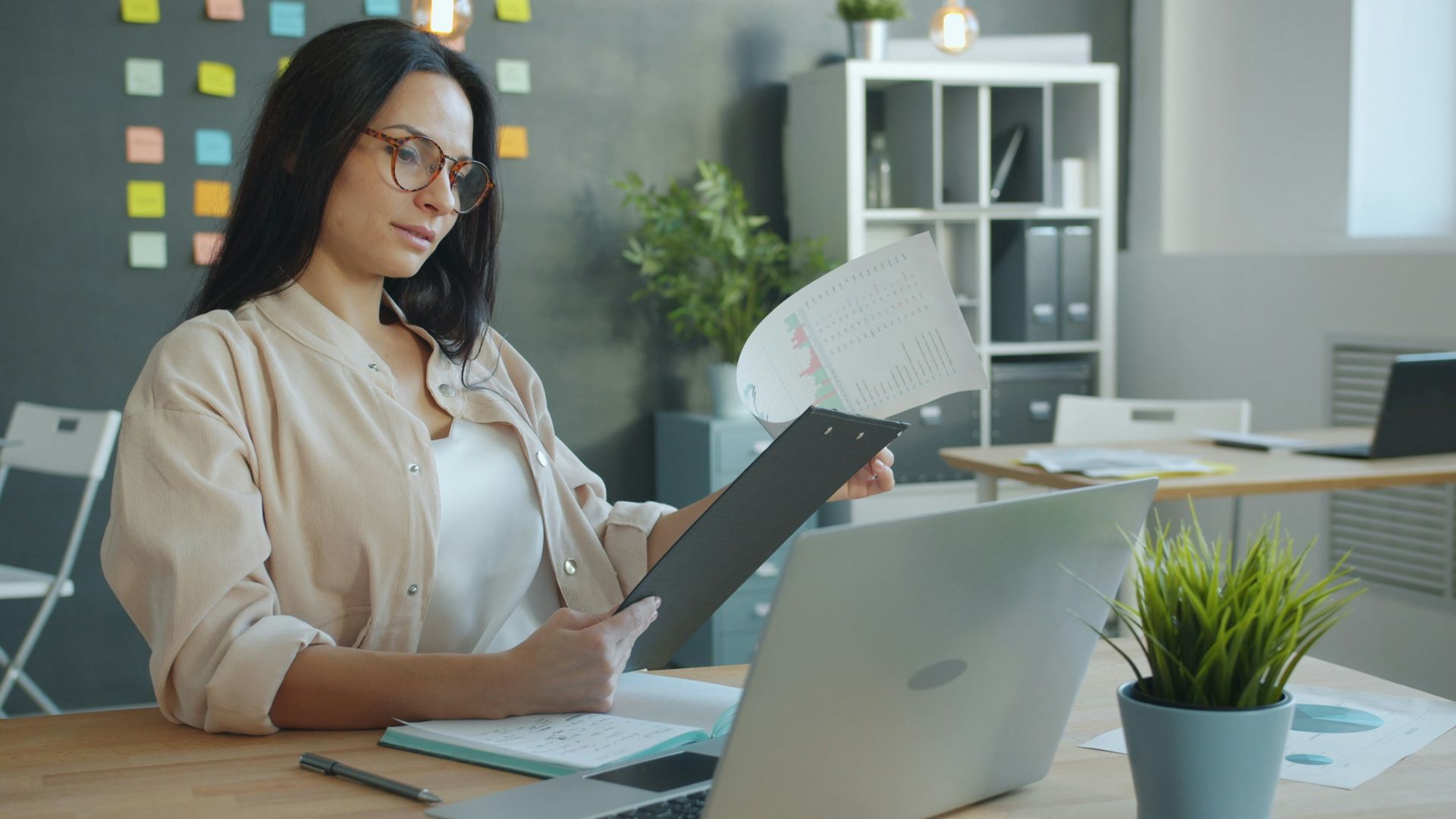 Woman working with documents at office desk