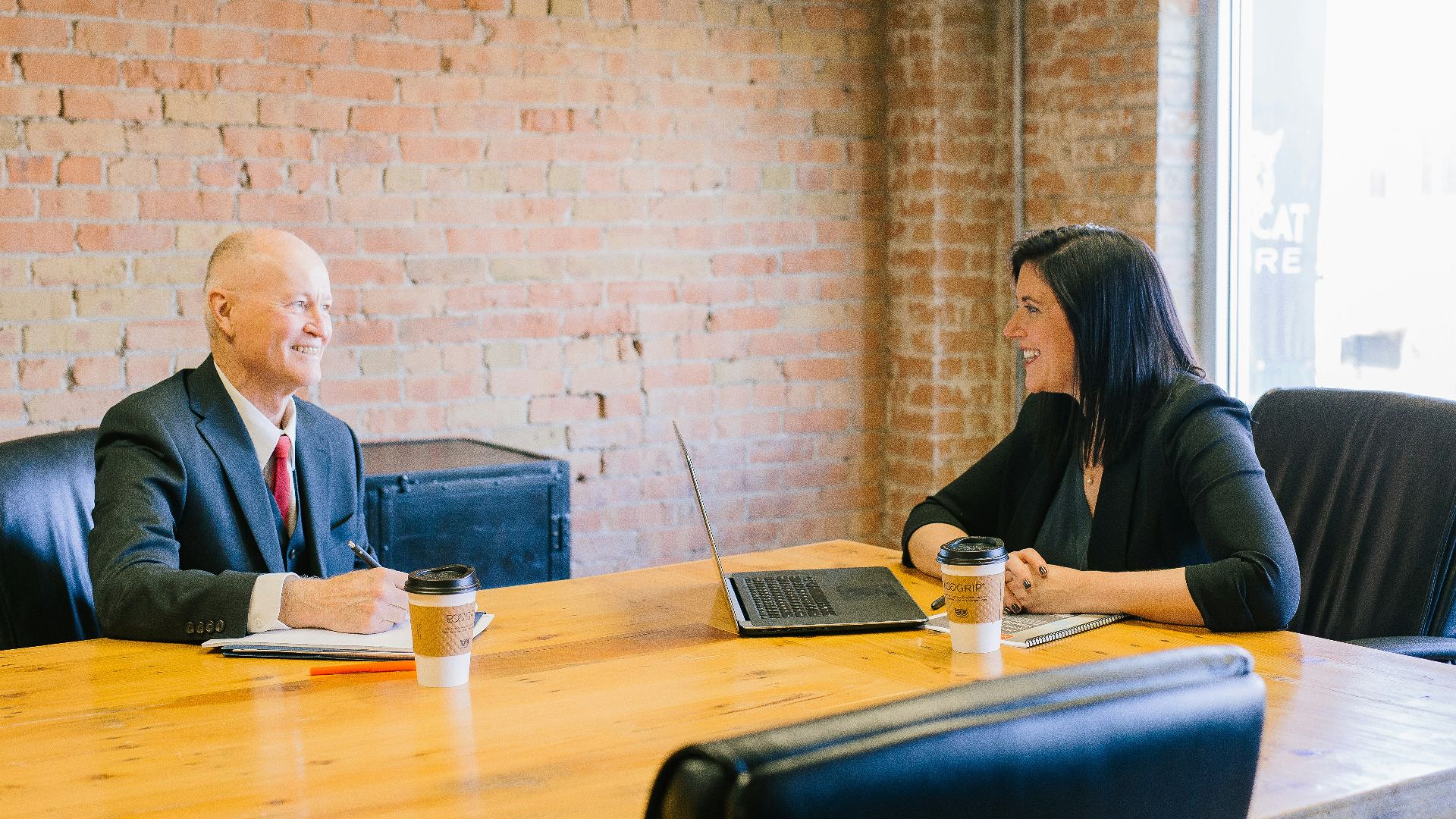 man and woman talking inside office
