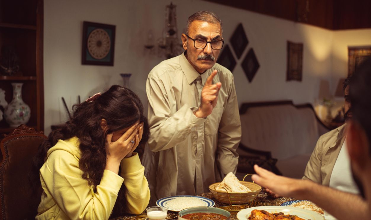 A tense moment with a family disagreement at the dinner table indoors
