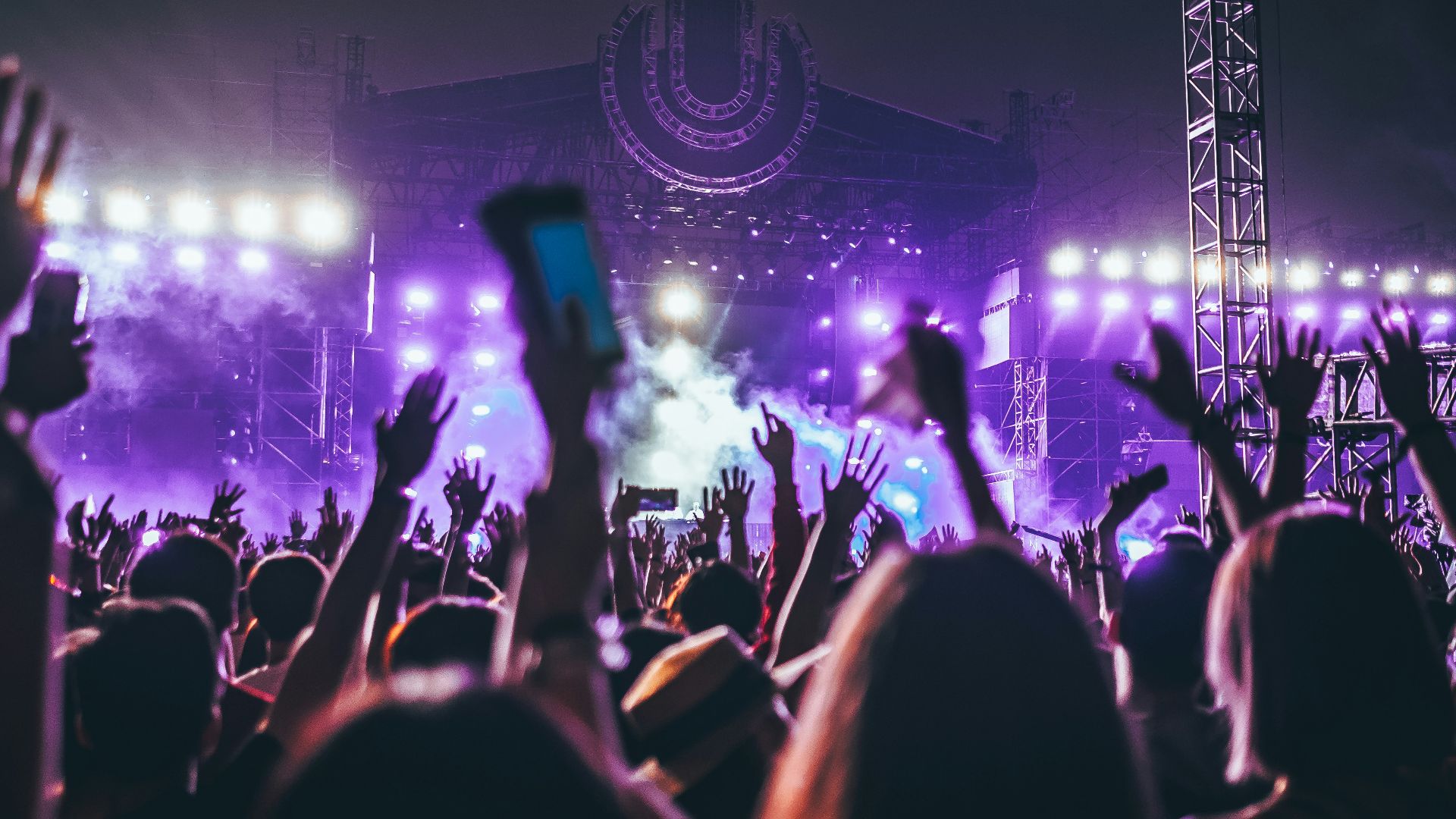 group of people raising there hands in concert