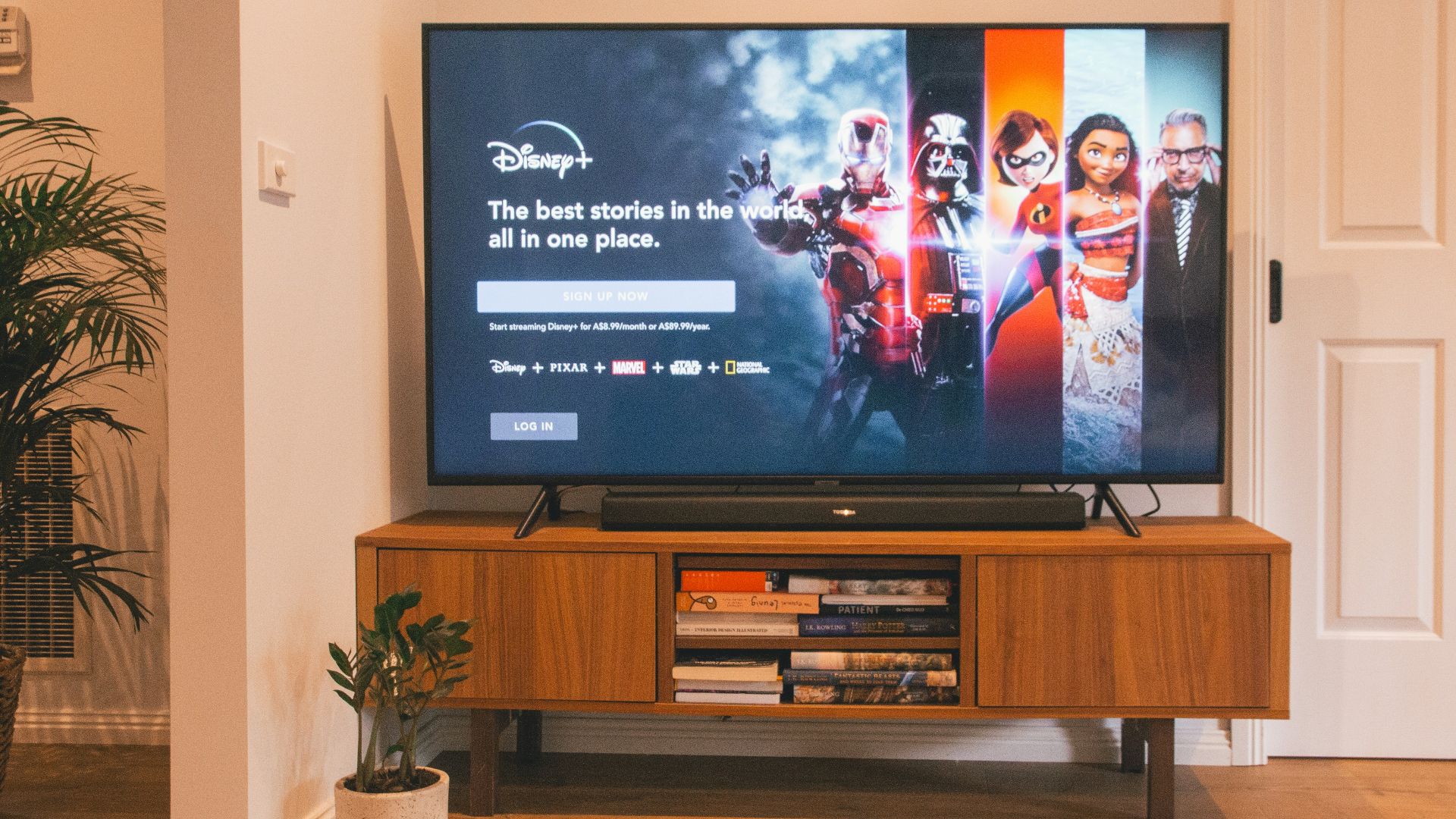 black flat screen tv turned on on brown wooden tv rack