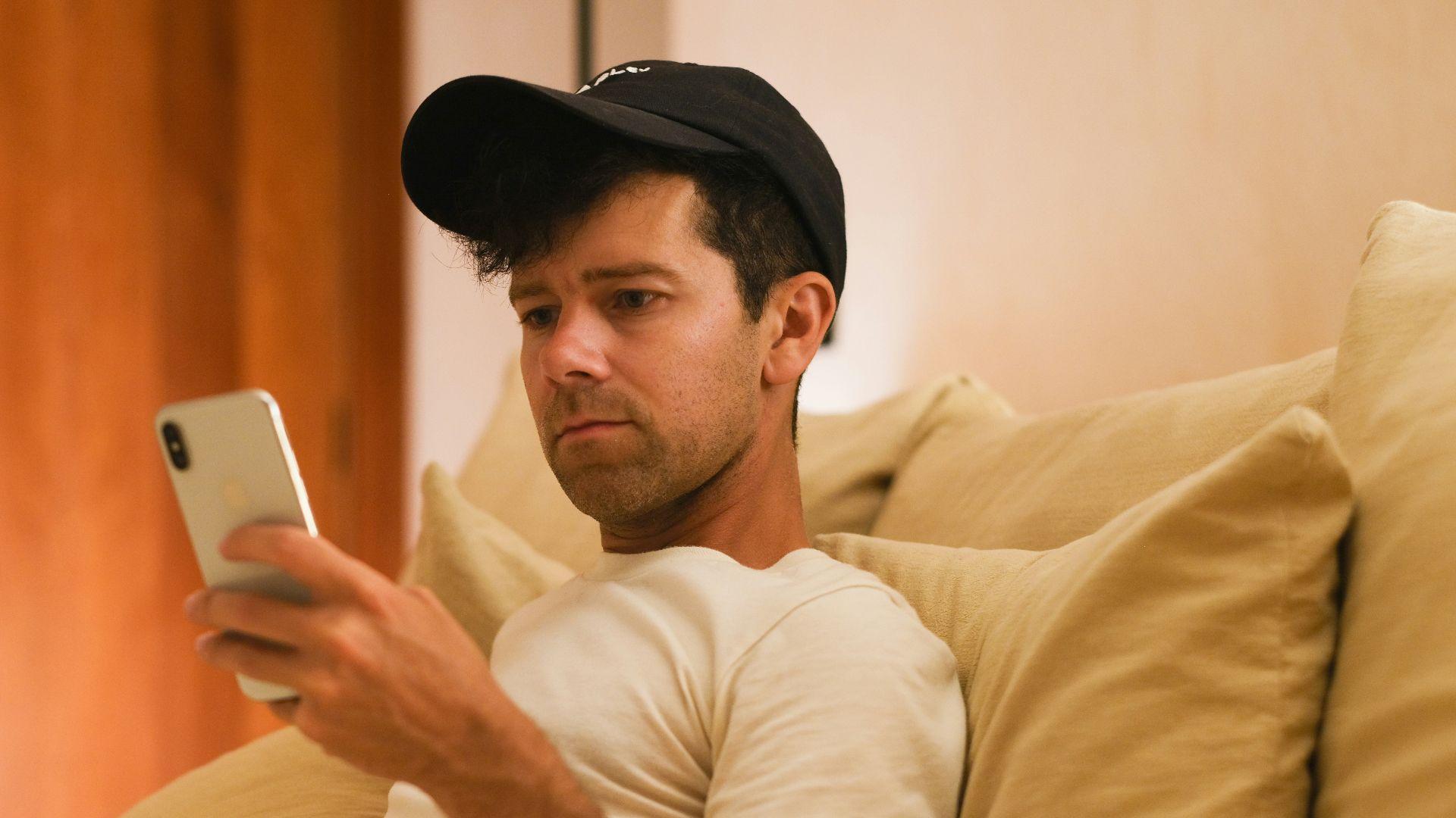 A man is focused on his phone.