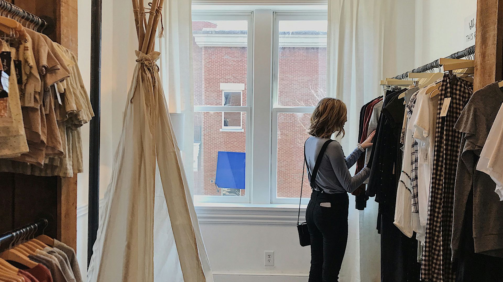 woman standing selecting clothes
