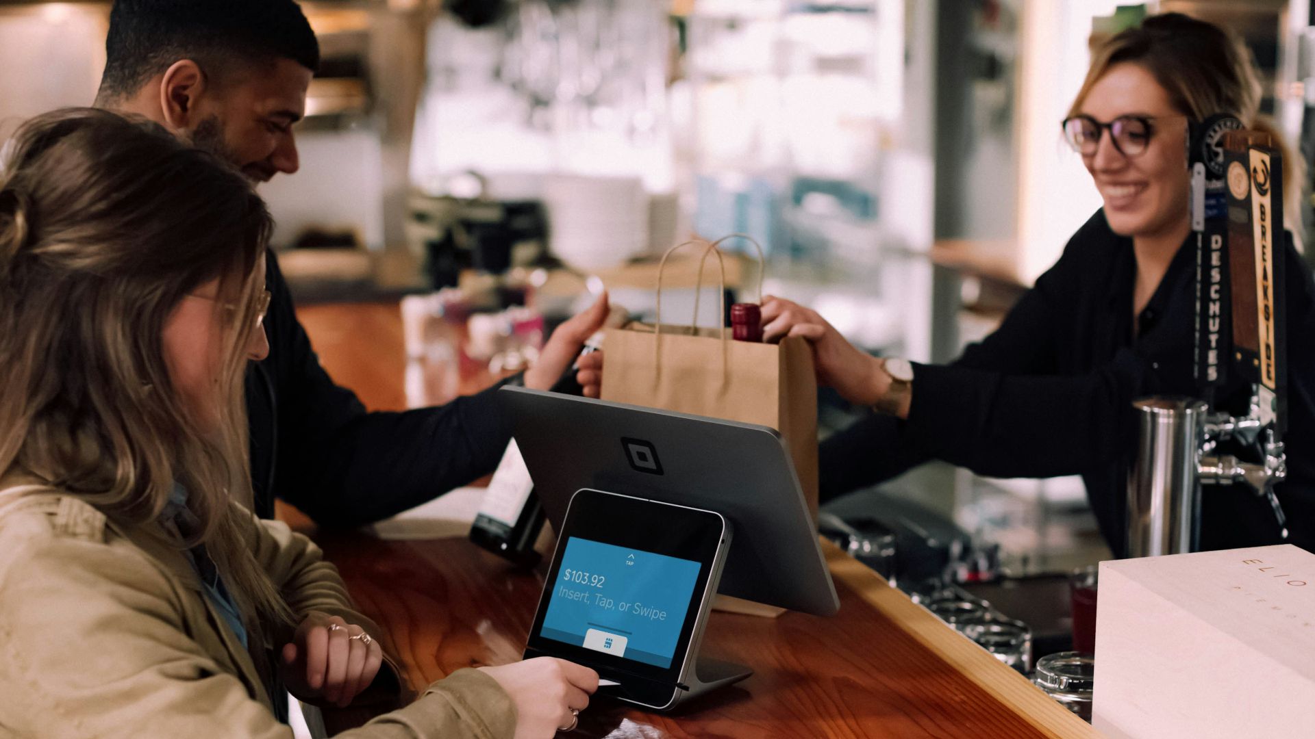 people using devices on brown table