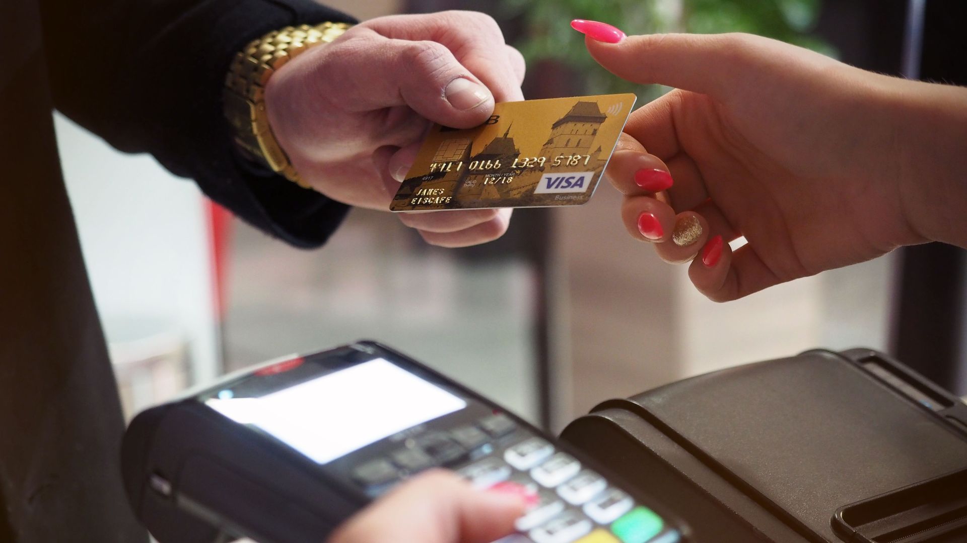 Close-up of a credit card payment being processed at a POS terminal.
