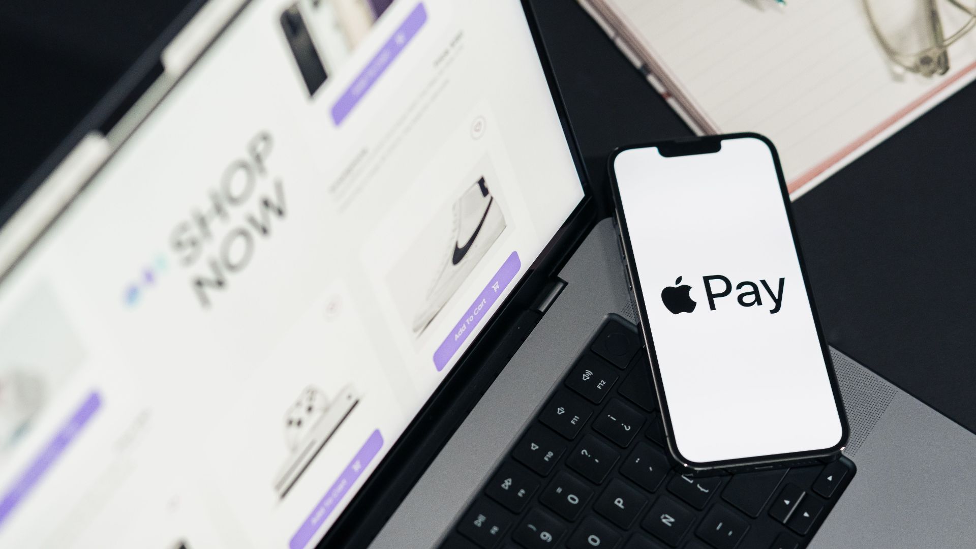Laptop and smartphone display facilitating online shopping using mobile payment technology.