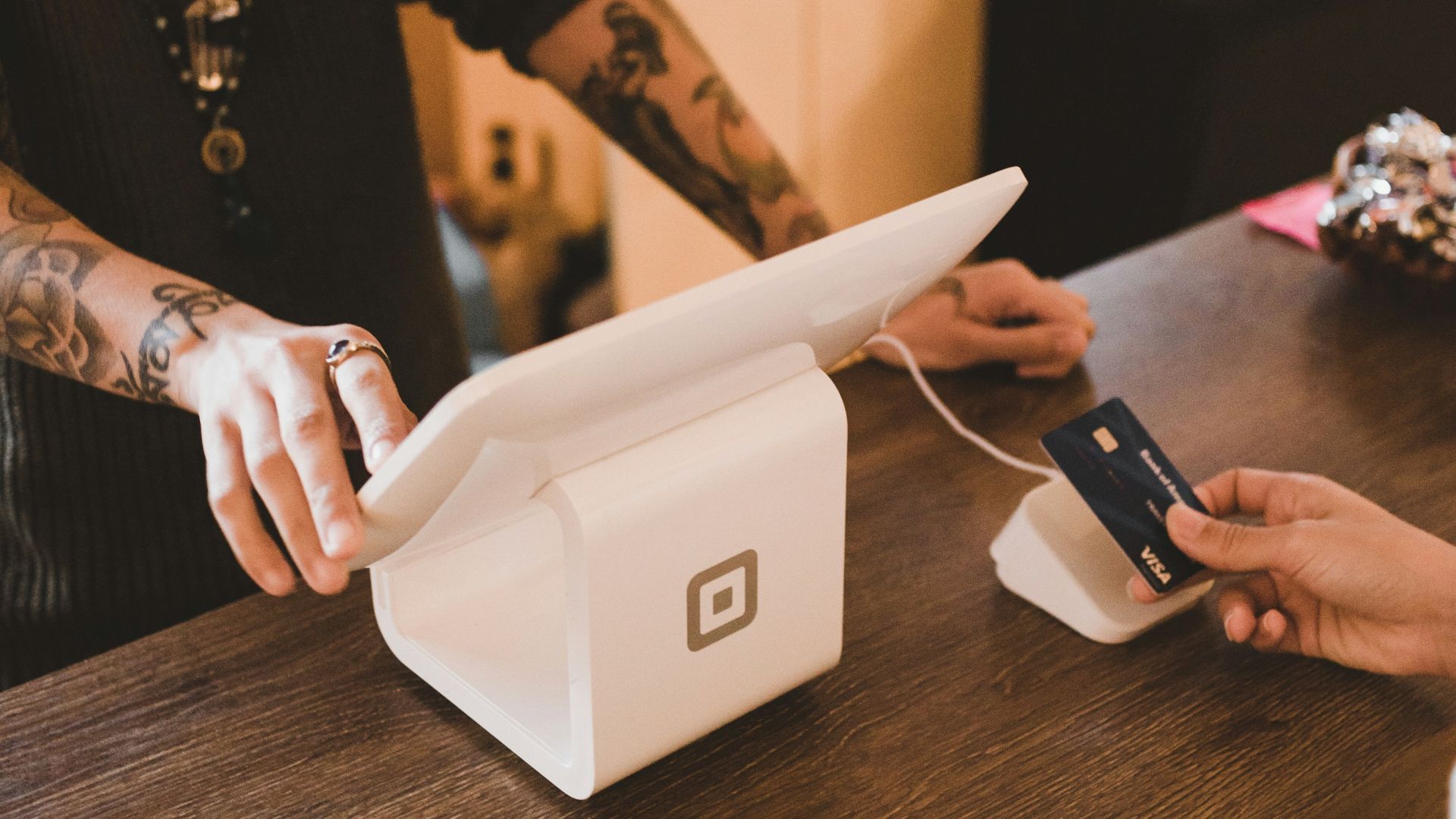 person holding white POS machine