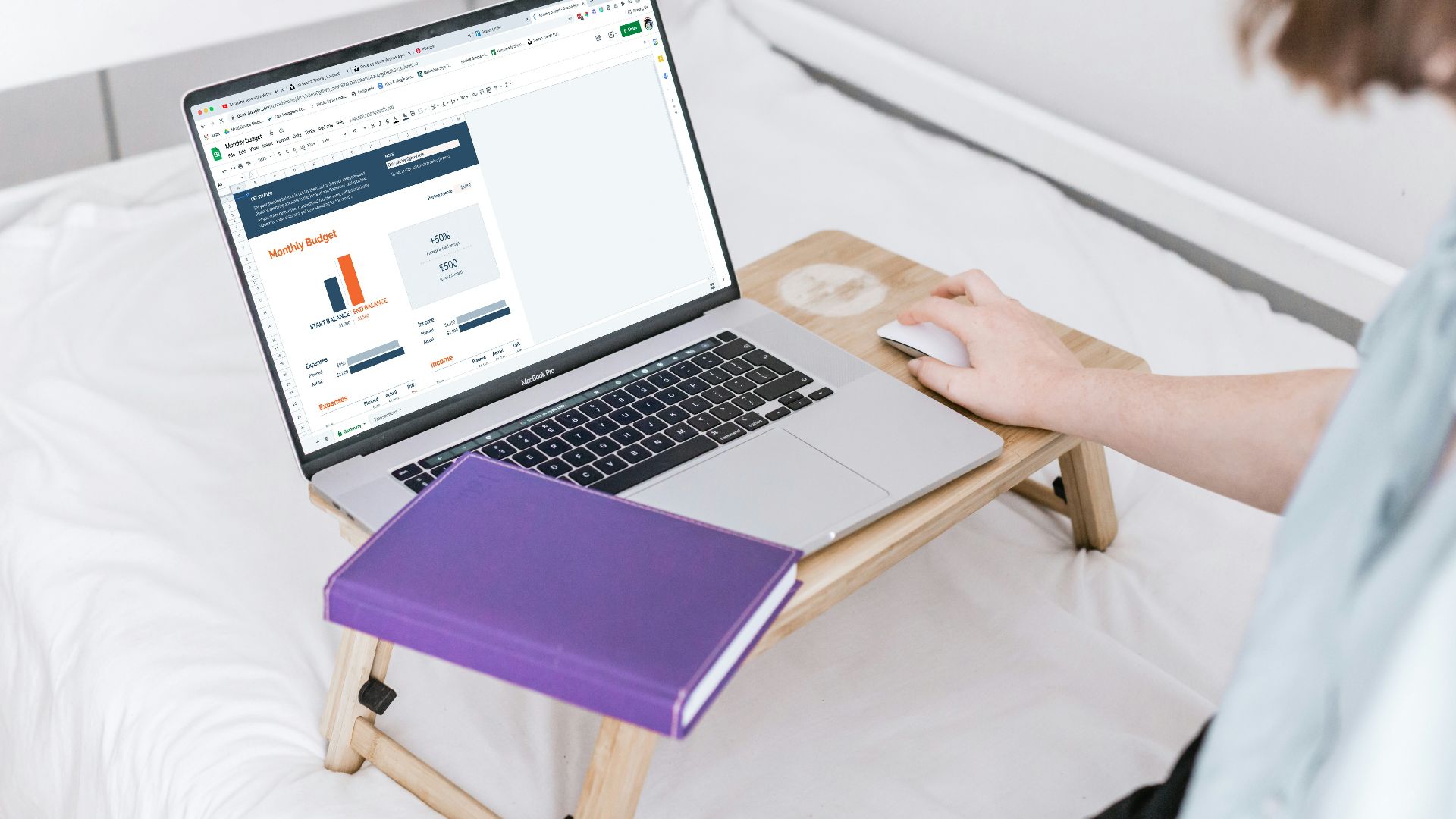 a person using a laptop on a bed