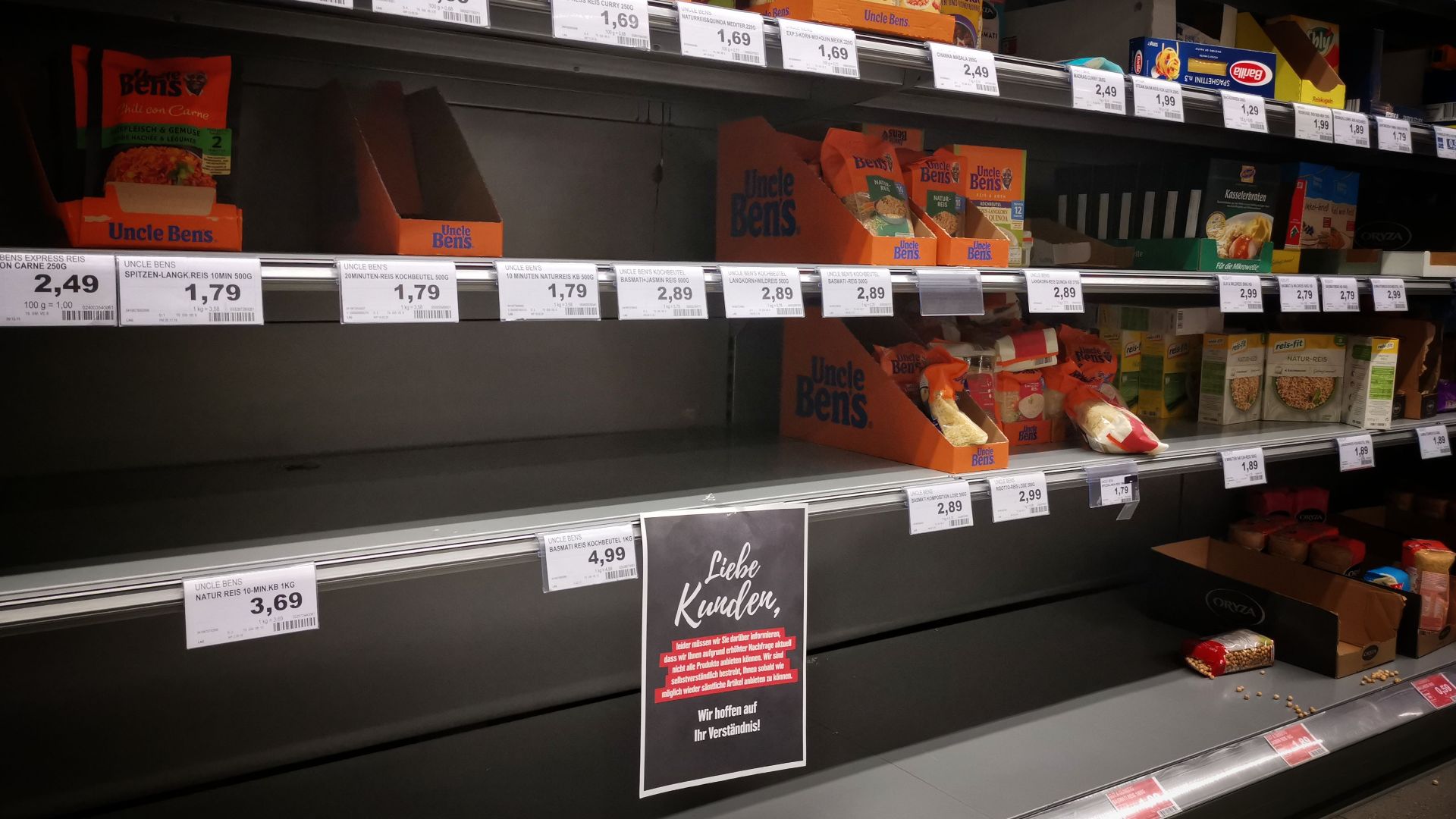Half empty shelves with assorted products in jars and containers in supermarket during quarantine