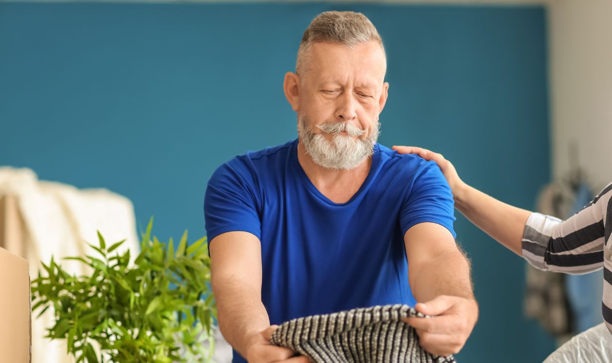Mature couple unpacking belongings at new home