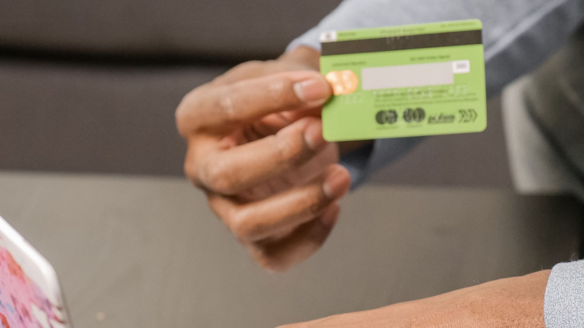 Person using laptop for online shopping with credit card, focusing on digital payment.