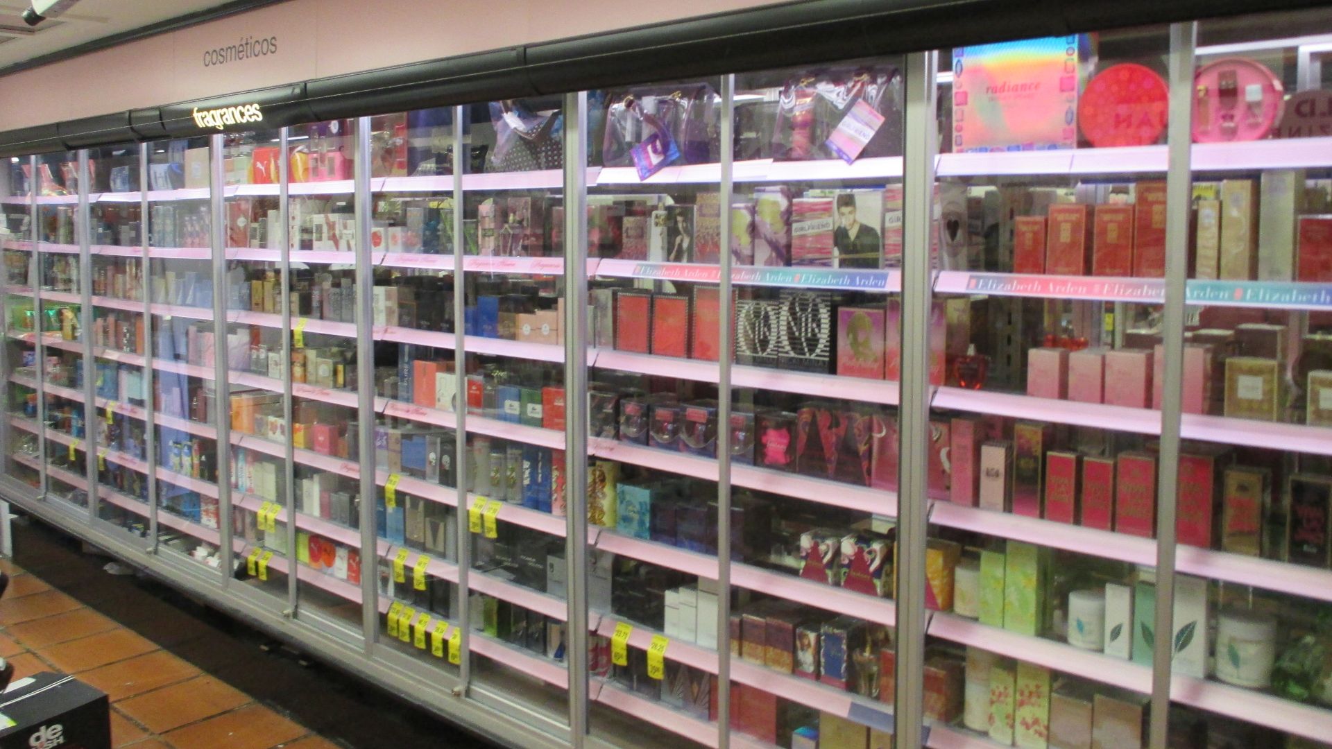 Shop with perfume bottles in locked shelves