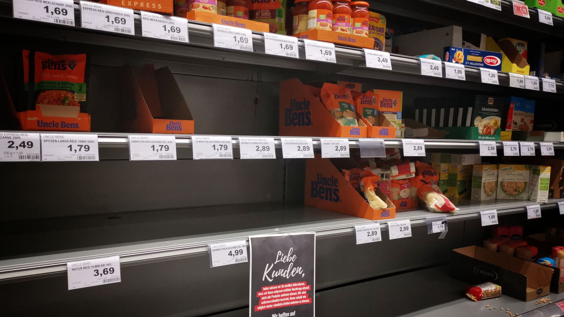 Half empty shelves with assorted products in jars and containers in supermarket during quarantine