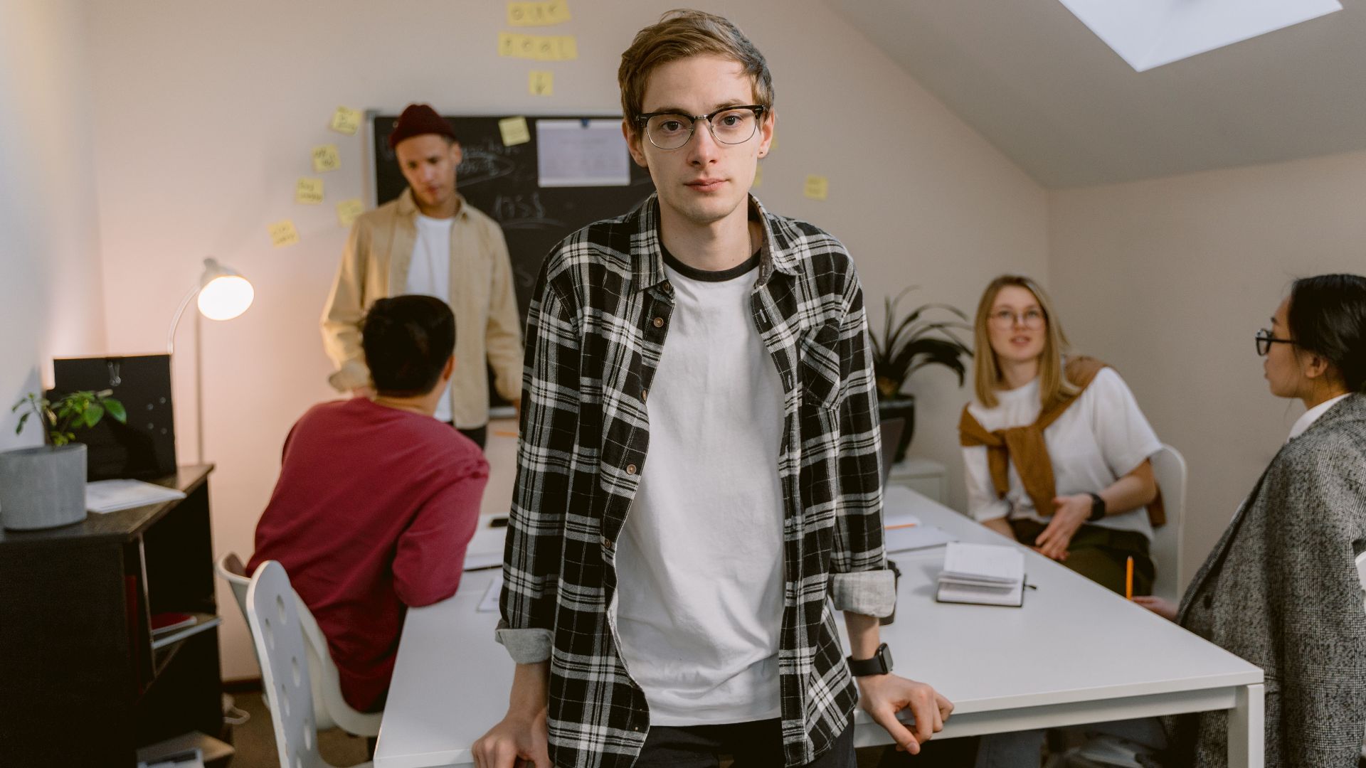 Young professionals engaging in a collaborative meeting in a modern office setting.