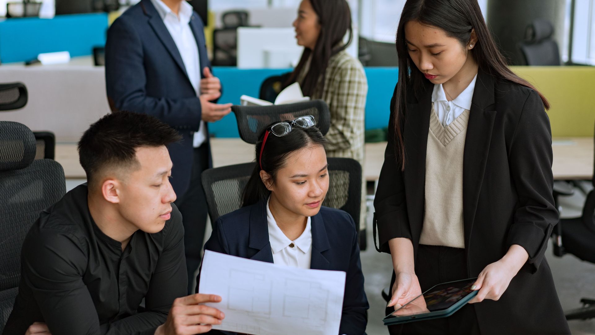 A diverse group of professionals brainstorming ideas together in a modern office setting.