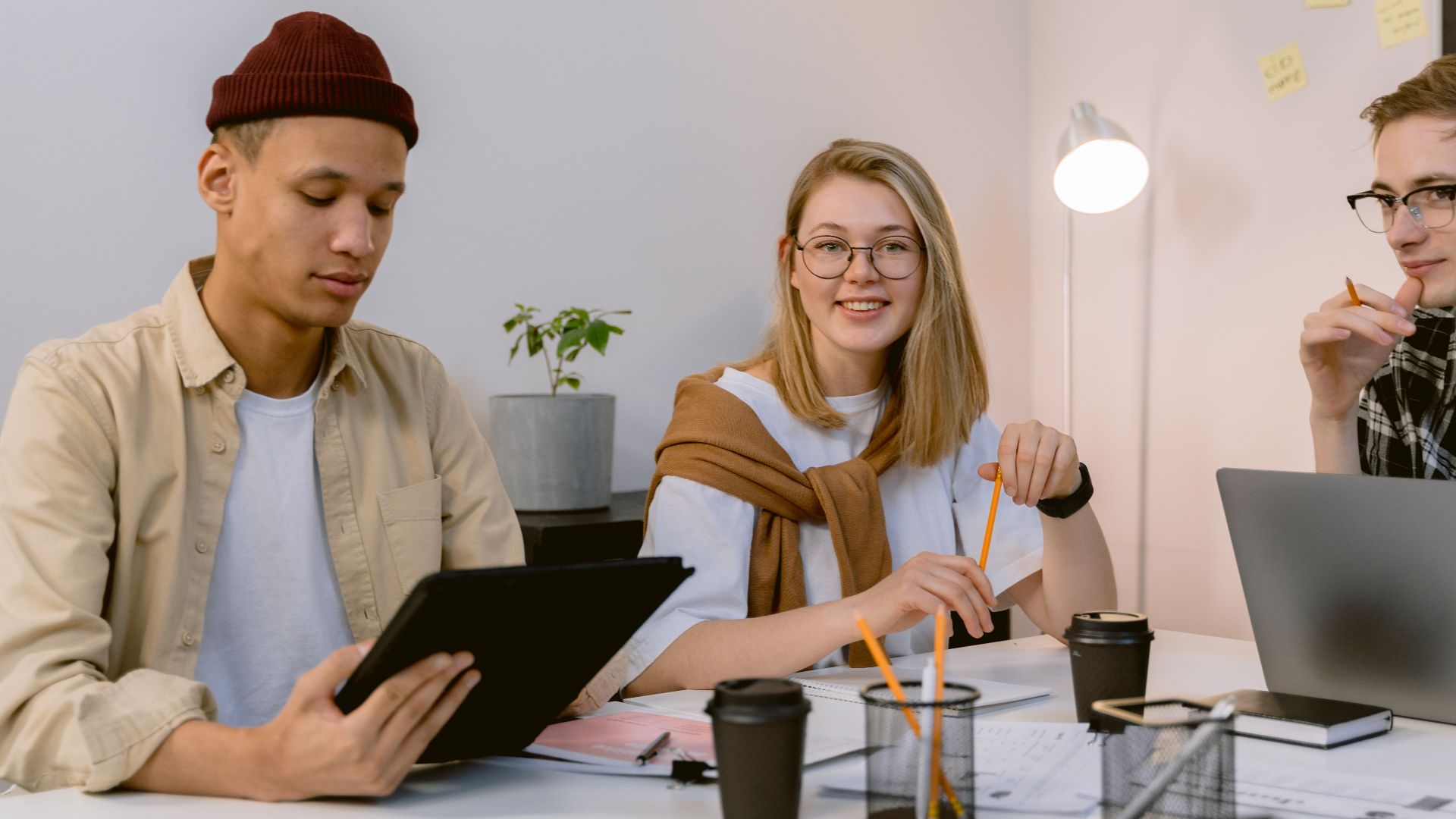 Young professionals engaged in a collaborative meeting in a modern office setting.