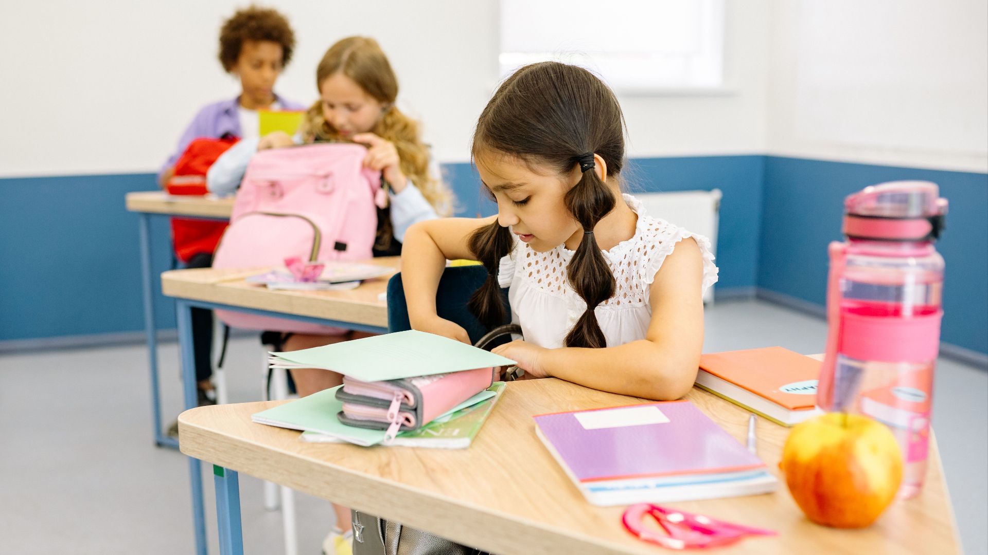 Diverse children participating actively in a colorful school classroom setting.