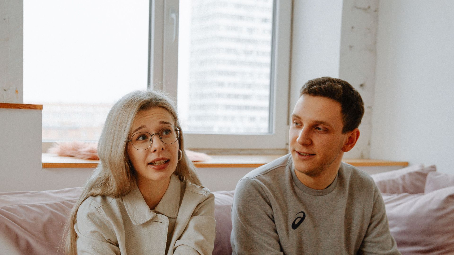 A couple and therapist engaged in a discussion during a therapy session indoors.
