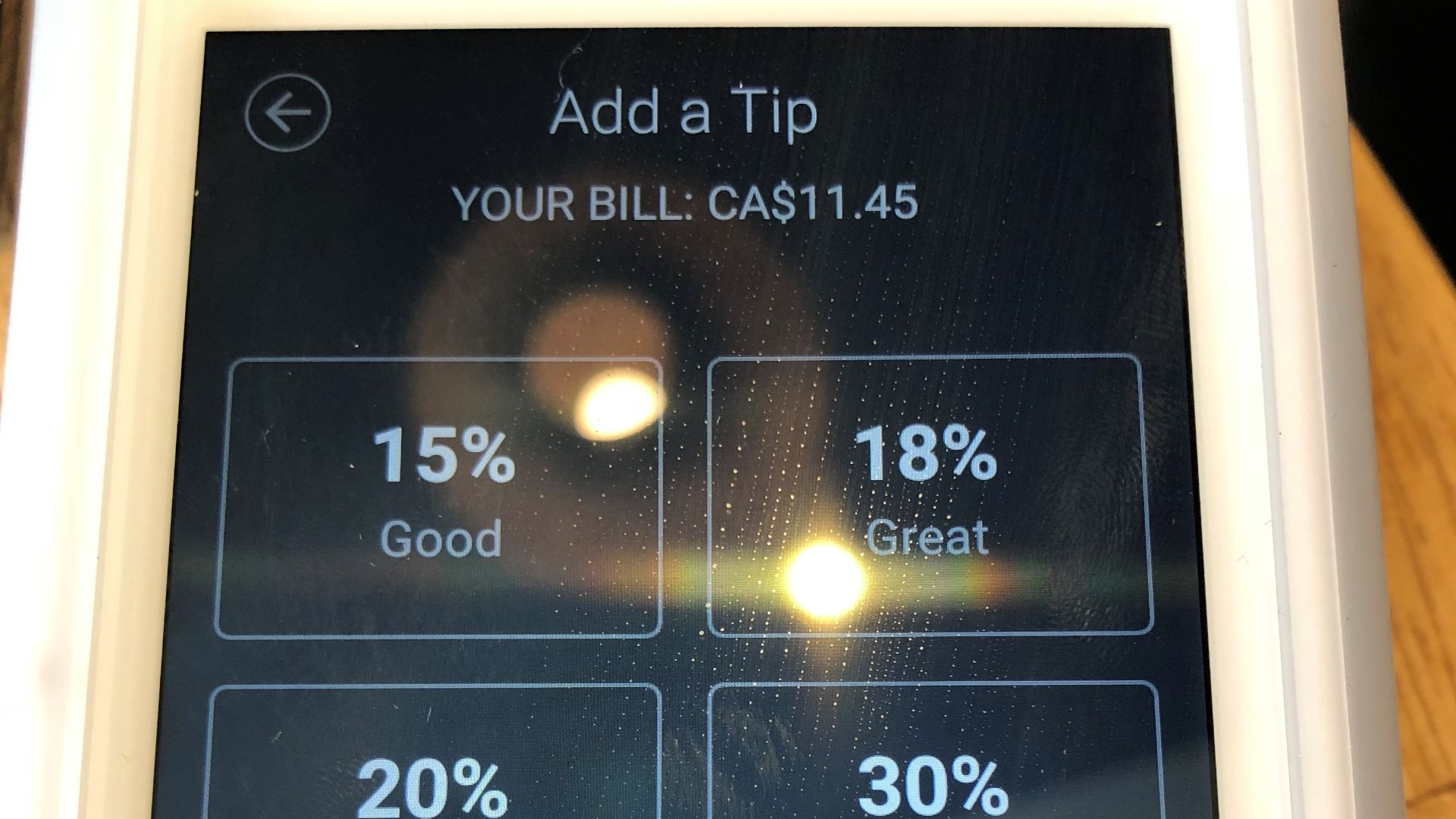 Tipping options on a chip card reader in a restaurant, Vancouver, Canada. 2019.