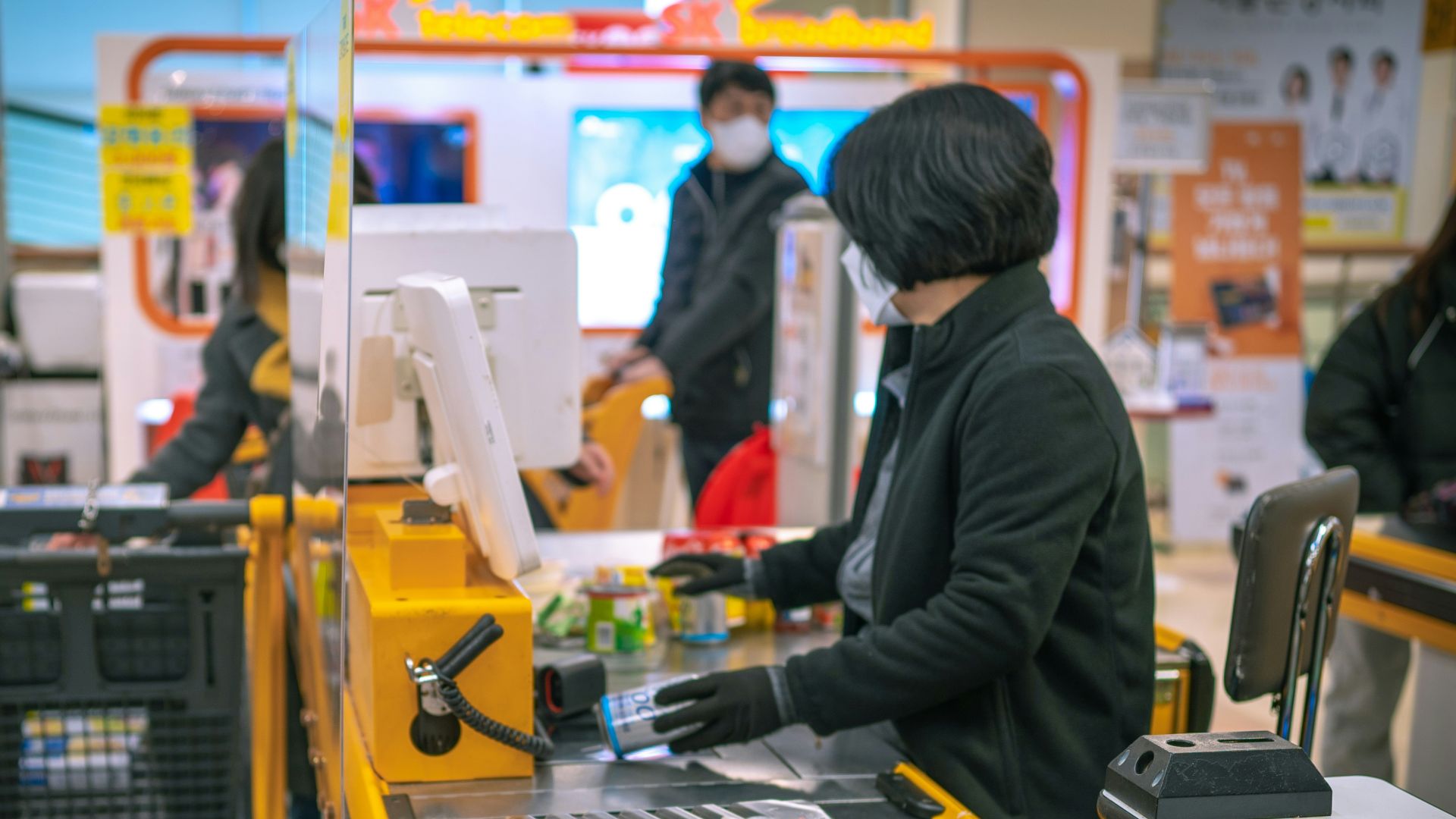a woman standing at a cash register in a store