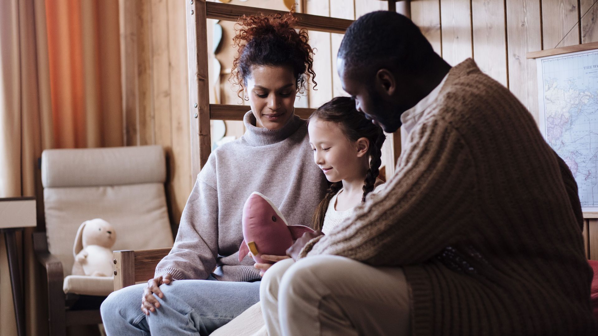 A loving family enjoying quality time together inside their cozy living room.