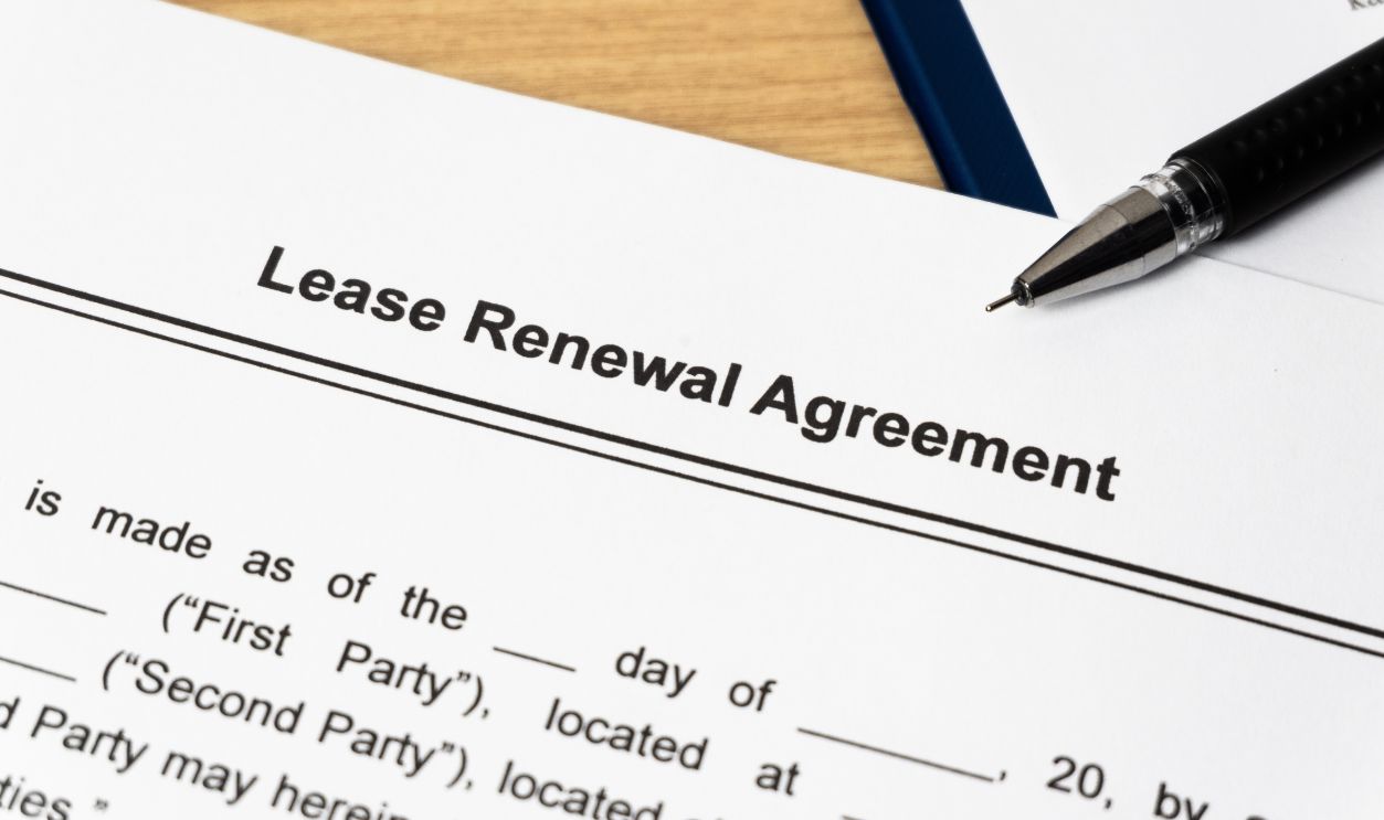 Legal document Lease Renewal Agreement on paper close up with pen