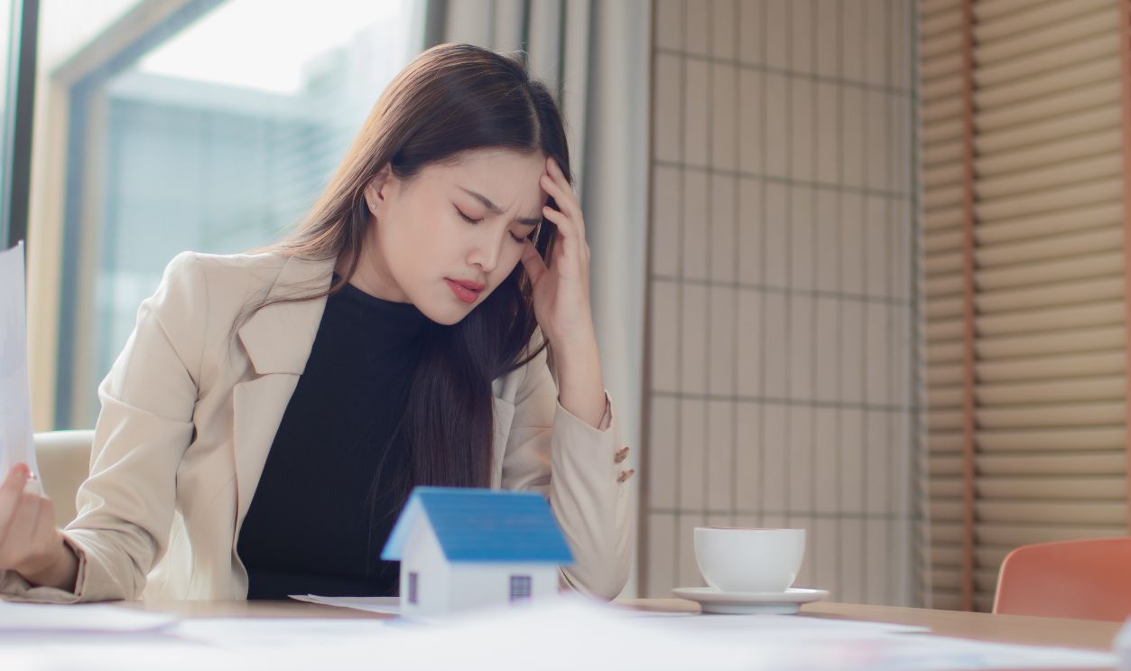 Stressed real estate agents face debt, bankruptcy, mortgage crisis, financial worries, taxes, loans, expenses, contracts, and housing market pressures.