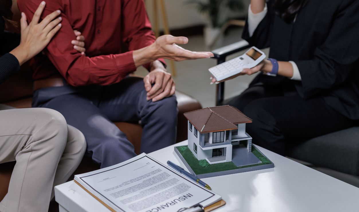 Couple having a consultation with a financial advisor about real estate investment and insurance