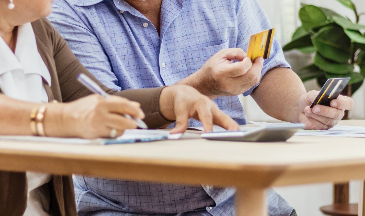 Stressed senior elderly couple conflict of credit card bills or debt of expense in shopping. Lover financial risk or crisis and bad habits of shopaholic. Lack of money discipline, planning & advisor