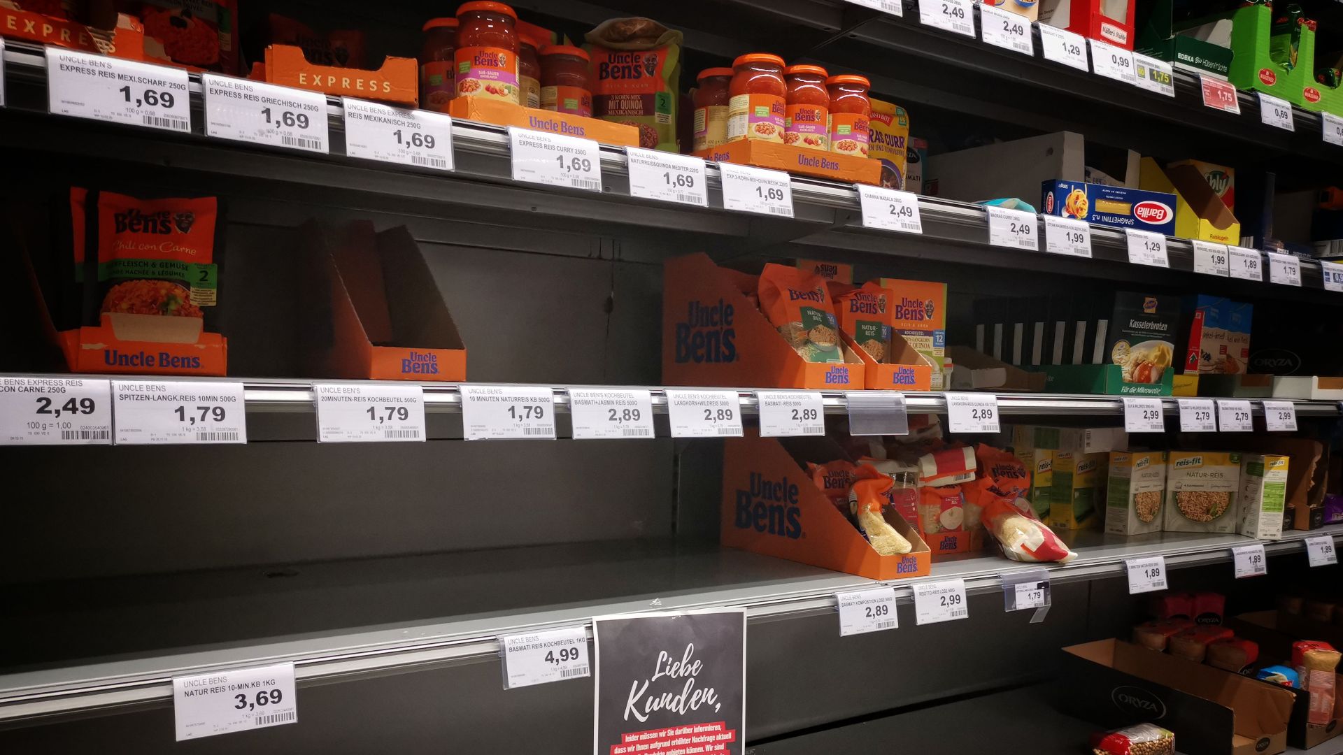 Half empty shelves with assorted products in jars and containers in supermarket during quarantine