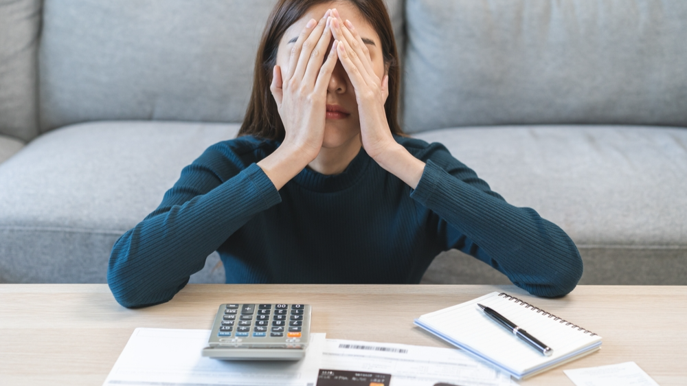 Stressed Woman sitting with covered face with hands