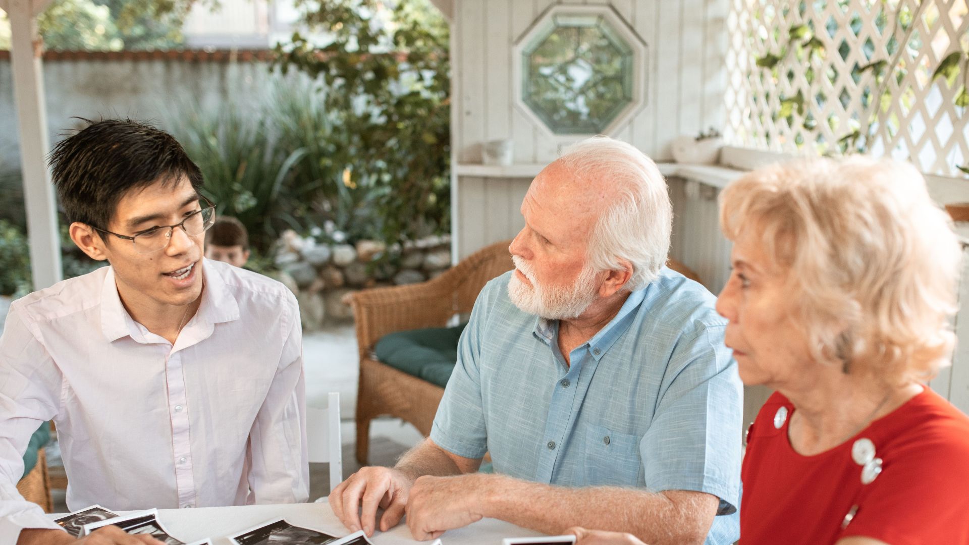 Family sits together discussing ultrasound images, celebrating new life.