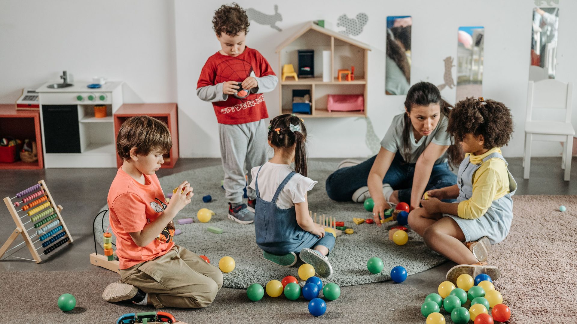 Young children and a teacher engaging in play and learning activities in a preschool setting.