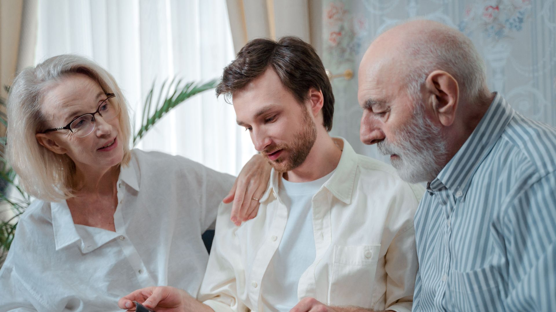 A family looks through a photo album, cherishing memories together indoors.