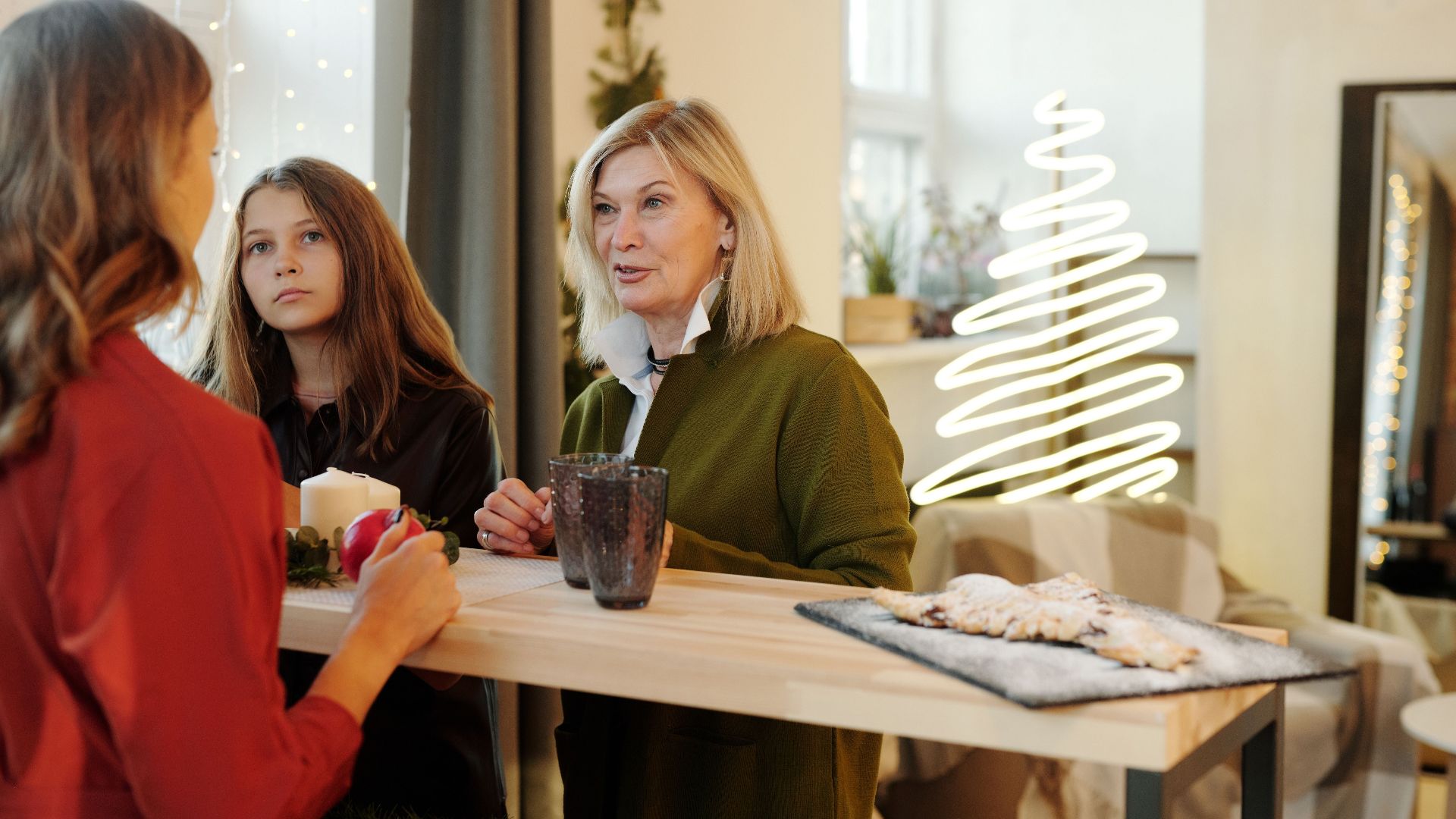 Family enjoying Christmas preparations in a cozy, decorated living room.