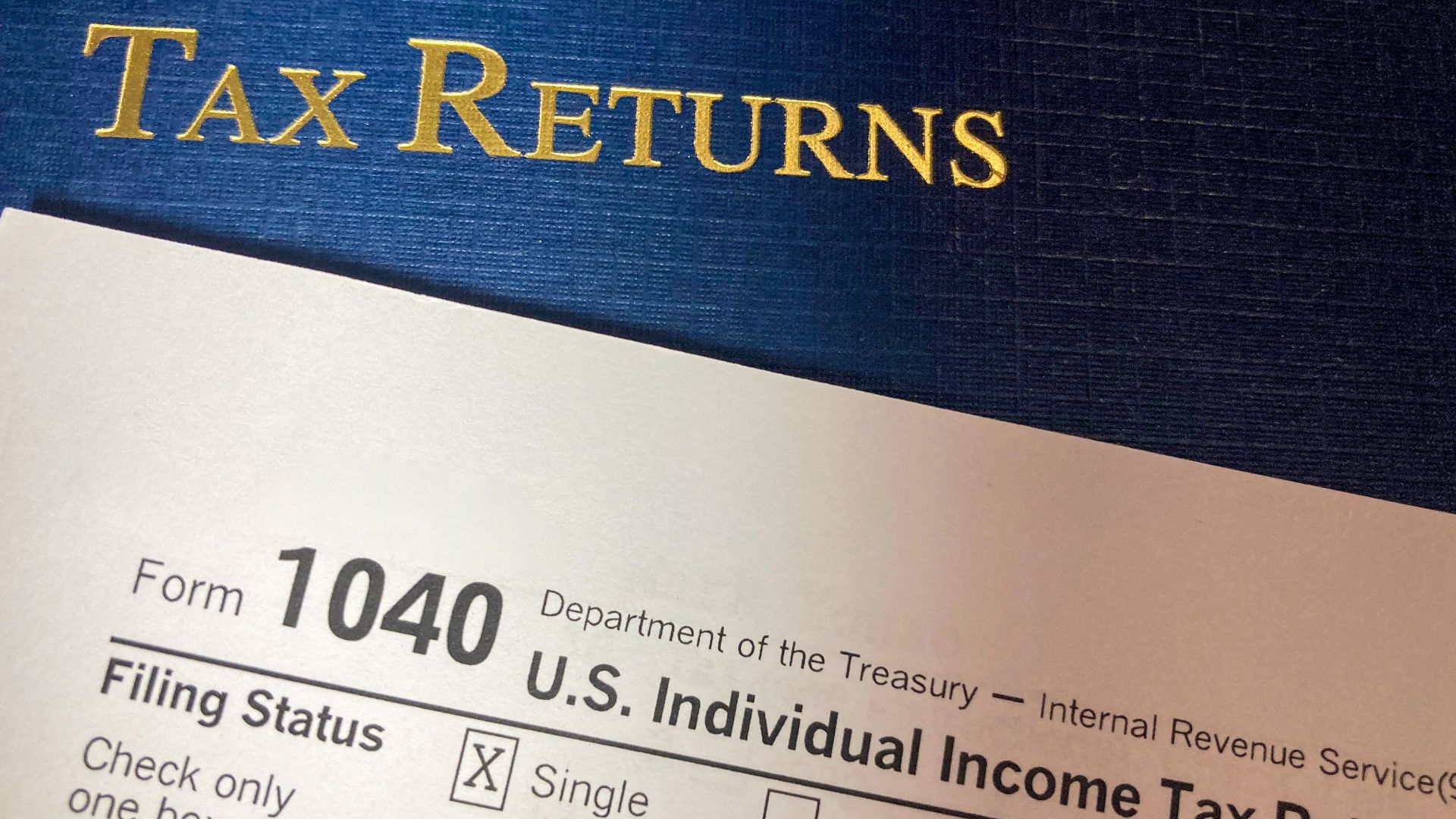 Close-up image of Form 1040 for U.S. tax returns, highlighting filing status options.